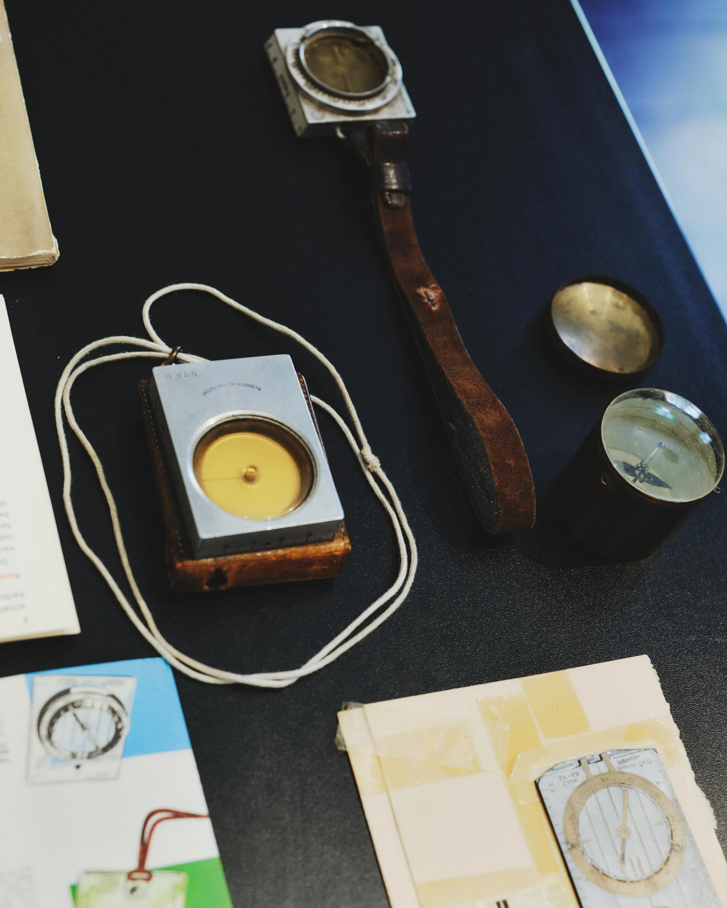  Vintage Suunto compasses and early navigation tools displayed as part of the Suunto 90 Archive exhibition. 