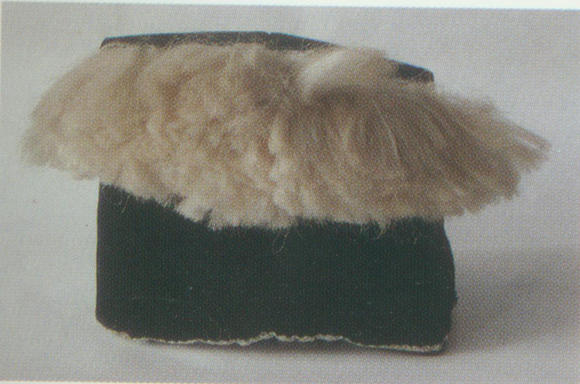 Dwarf Scarf A soft hat. Its style is similar to a felt hat. It is made of black satin and black fine cloth, topped with silk tassels. The dwarf scarf is well-known for being worn by Wu Dalang, a major character in The Gallant Swordsman . 