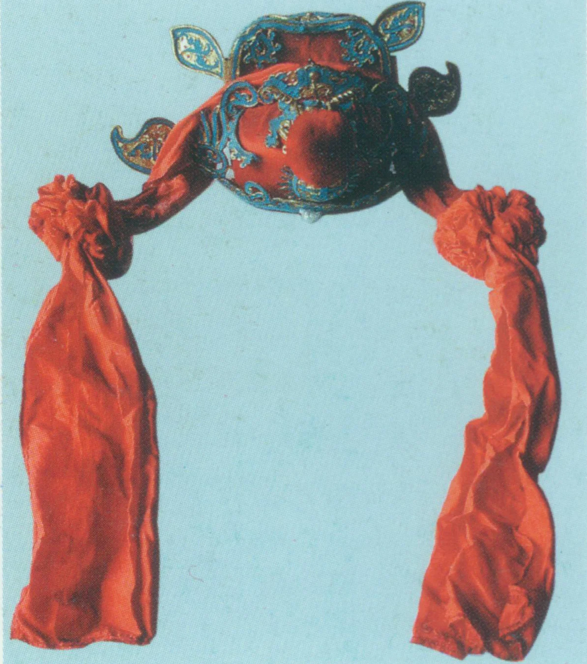 Judge Hat A rigid helmet. It resembles square gauze hat in looks. There is a round warped- shou (a Chinese character meaning longevity) encircled flame at the frontal center and a big red velvet ball atop. It also has a pair of wings pointing upwards is in the behind, with other ornaments such as beads, bats and velvet balls. It is commonly seen in red or black. Only judges and the like in Chinese mythologies wear this hat. For example, Zhong Kui just wears a judge hat in the Act “The marriage of Zhongkui’s younger sister” of Happy Endings for Everyone .