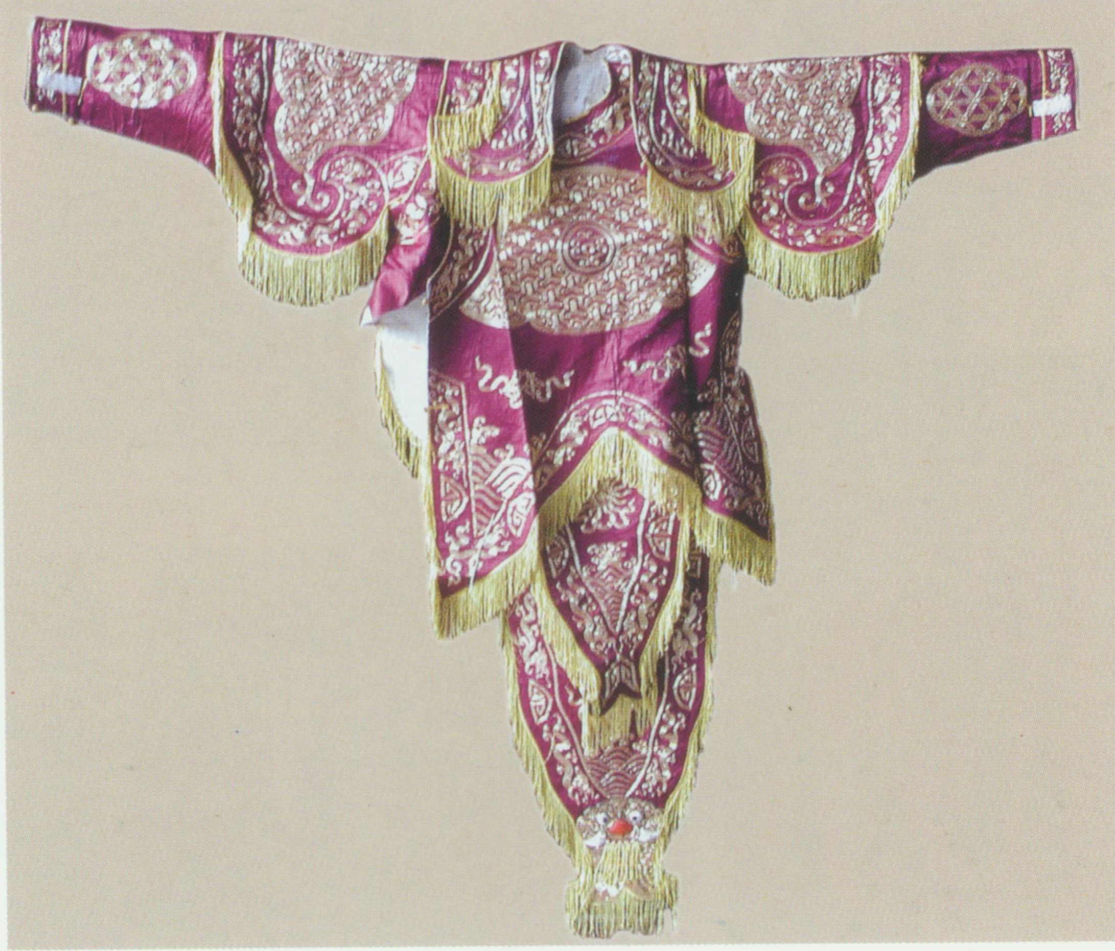 Armour Costume worn by generals, also known as “protective clothing” ( jiayi ). The slightly wide cloth tied around the belly is called “ kaodu ” (literally meaning “the central part of the armour suit”), and the cloth covering either leg is called “ kaotui ” (literally meaning “the leg-part of the armour suit). This armour suit is covered with embroidered patterns symbolizing thin metal plates that are used in the real armour. If flags are attached to the back, then the suit is called “hard armour” or “hard kao ”; otherwise, it is called “soft armour” or “soft kao ”. Men and women wear different types of armour. 