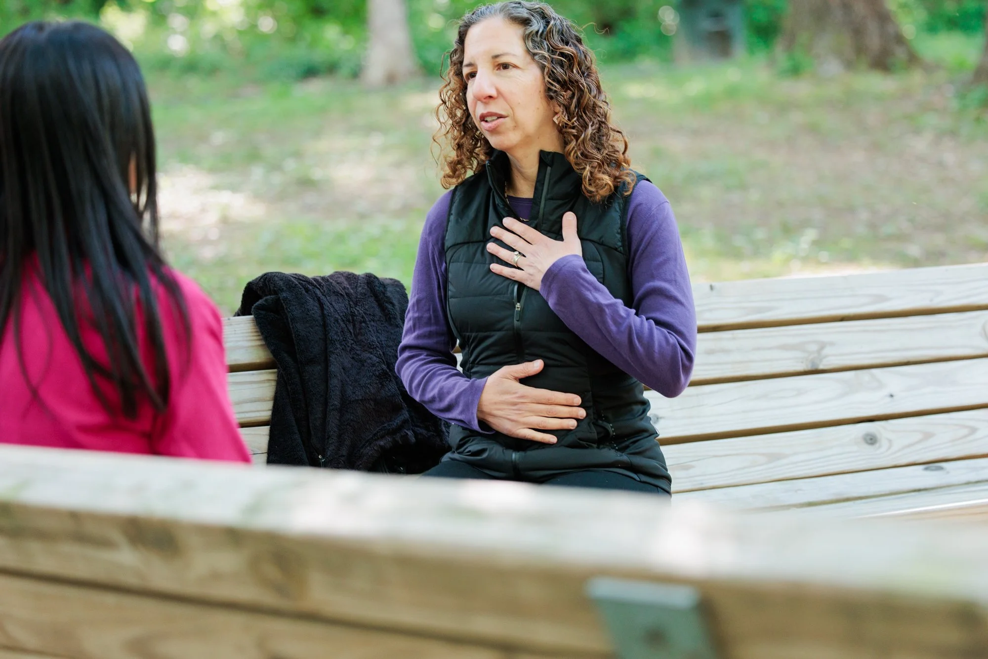 therapist practicing breathing exercises on park bench in Maryland