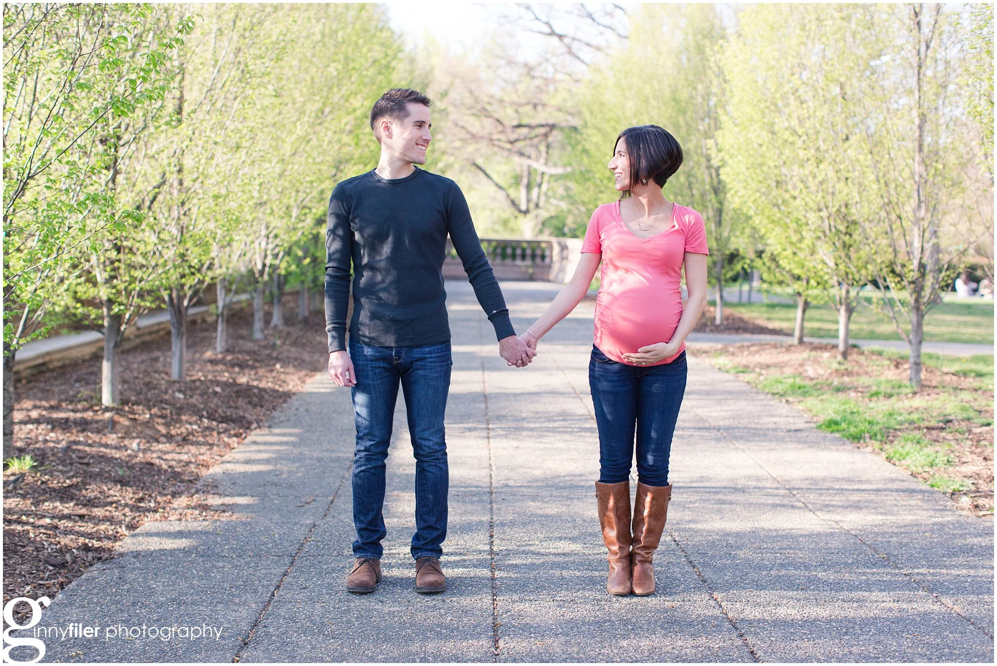 pregnant woman and husband holding hands in washington dc park for maternity session