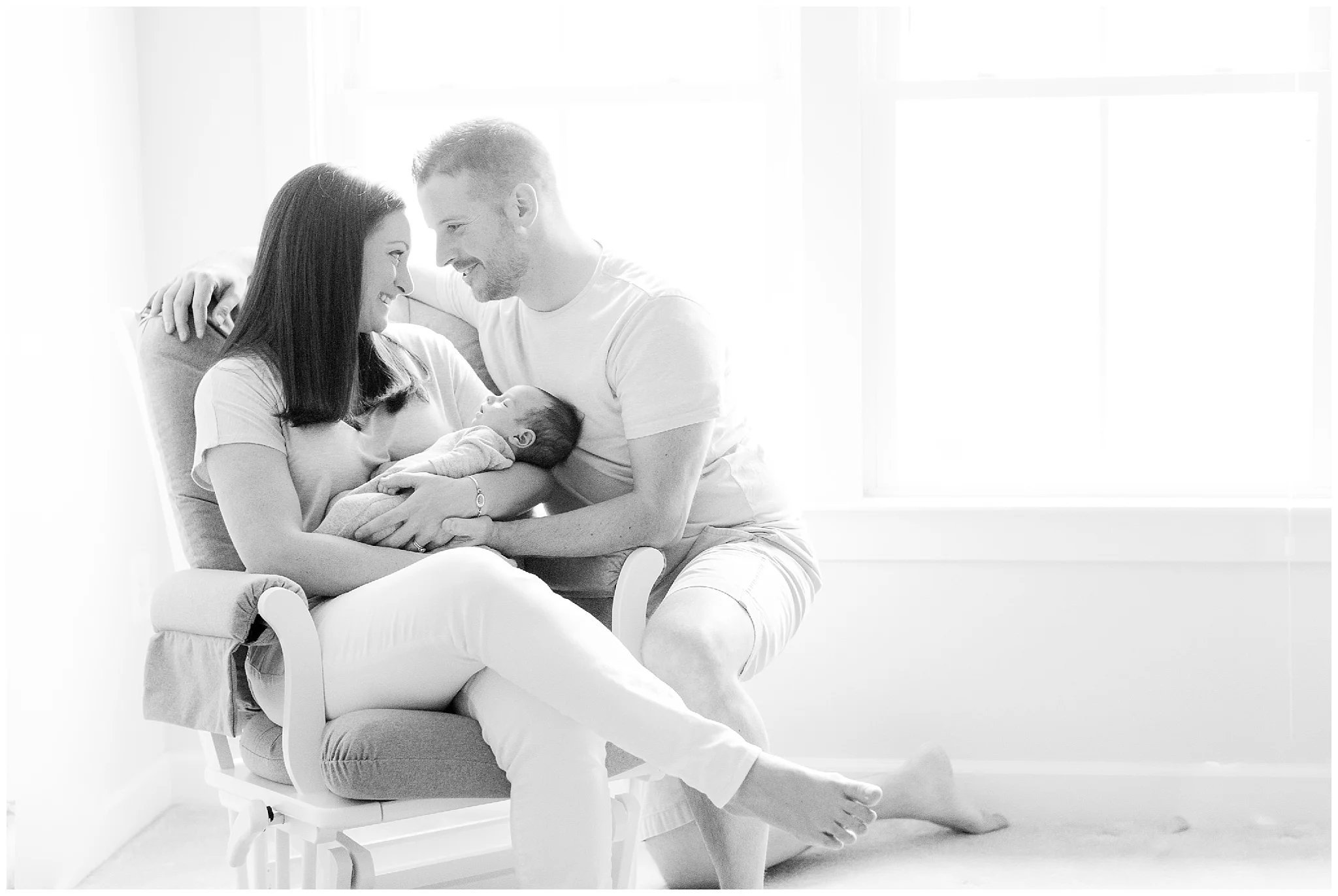Lifestyle newborn photography in home in Silver Spring MD with baby and parents.
