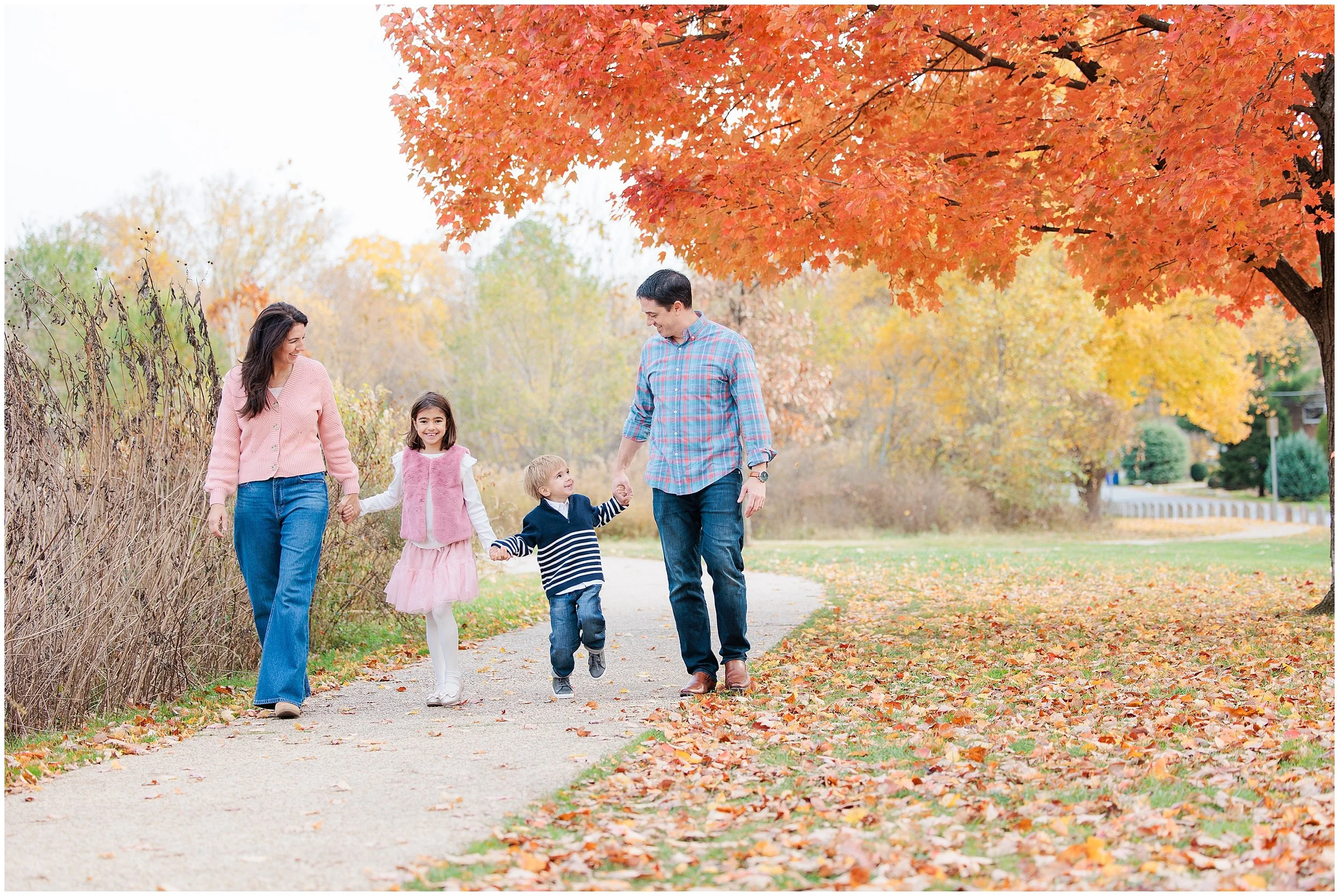 fall walking under orange tree during sliver spring mini session