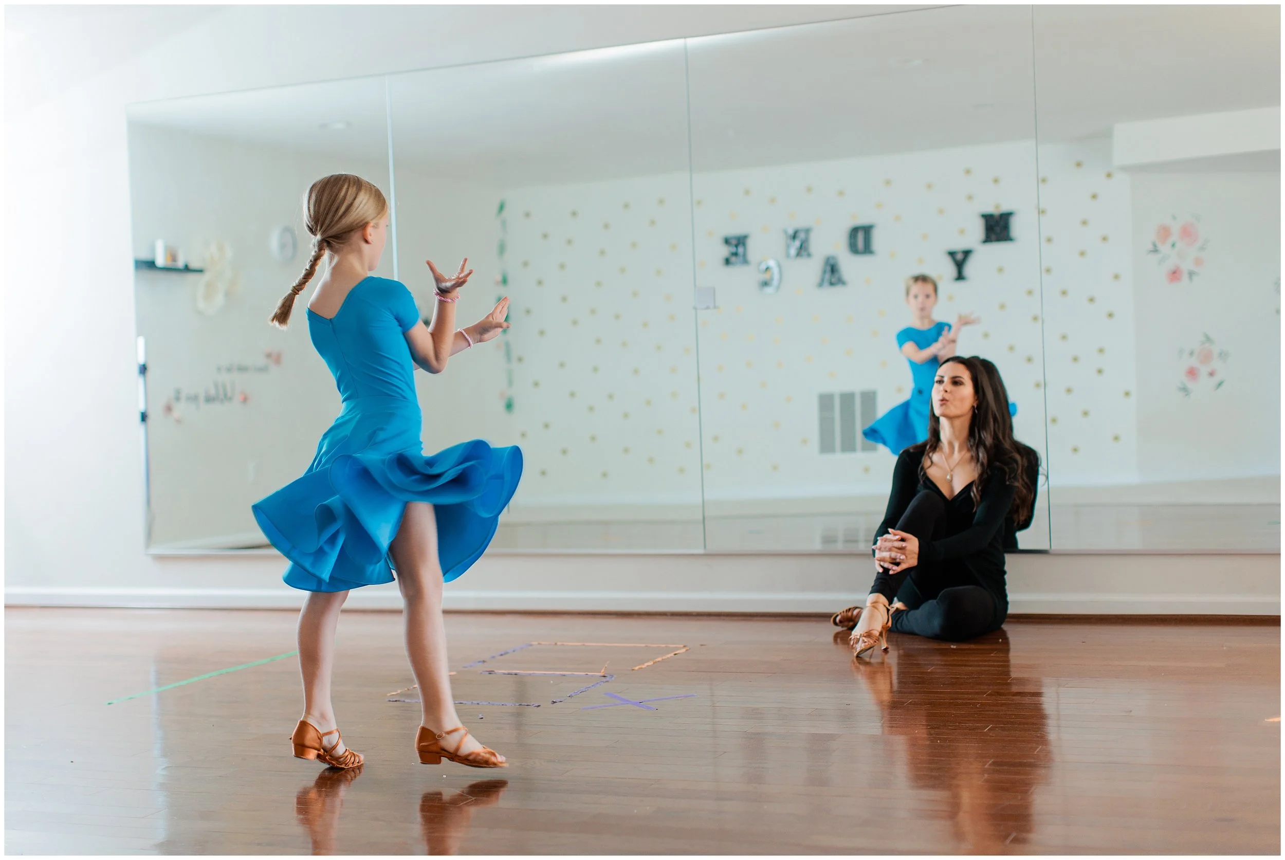 dance teacher giving instructor to child student