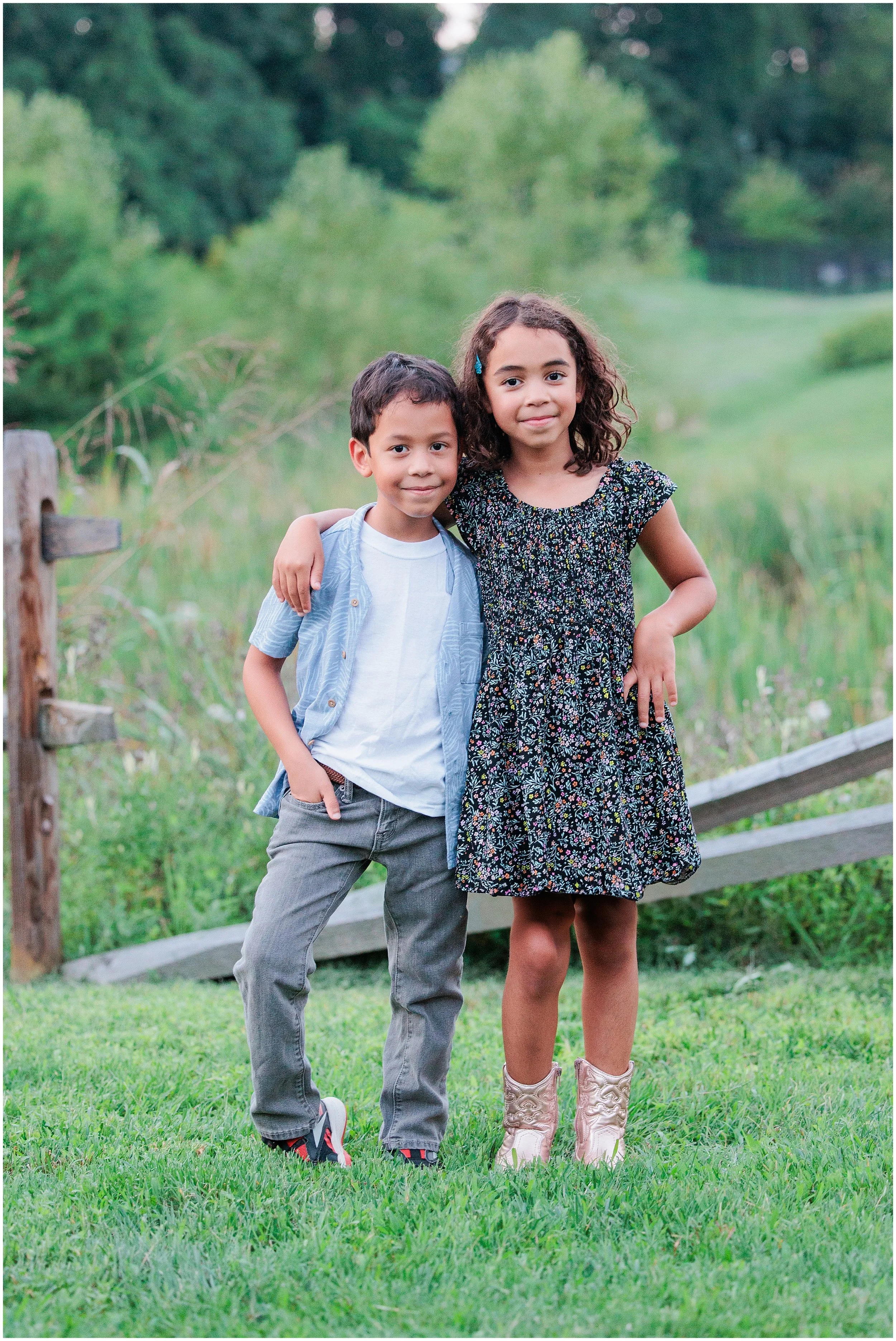 brother and sister posing for family photo in maryland