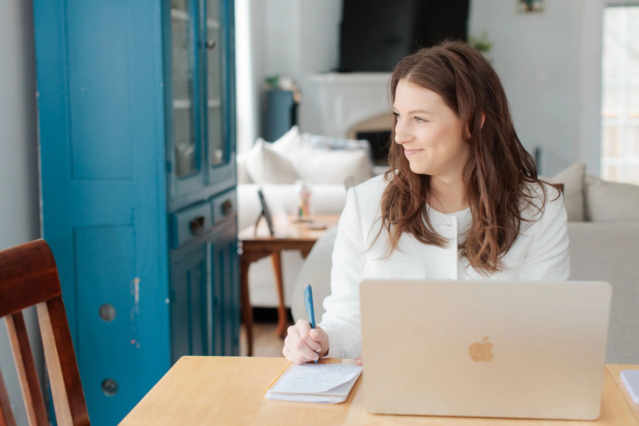 brand photo of female looking out the window and smiling
