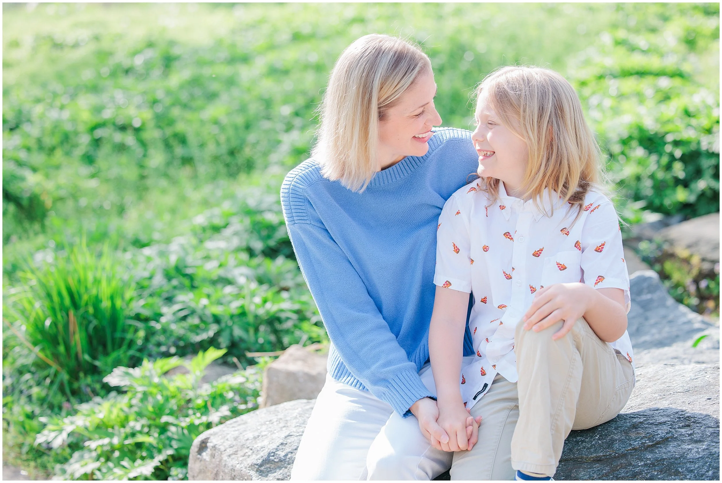 mom and son sitting on rock in Robinson nature center in maryland for family photography