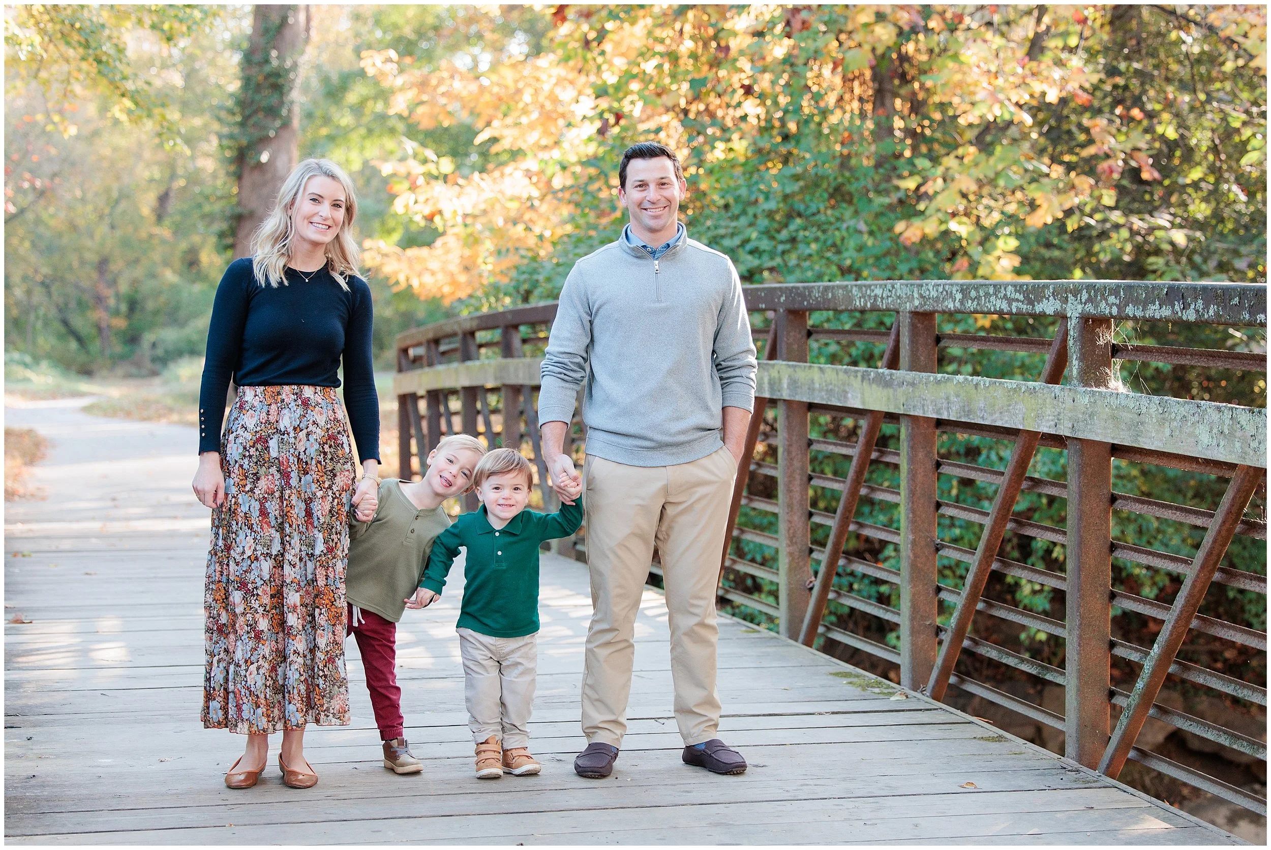 family smiling at camera for fall family session