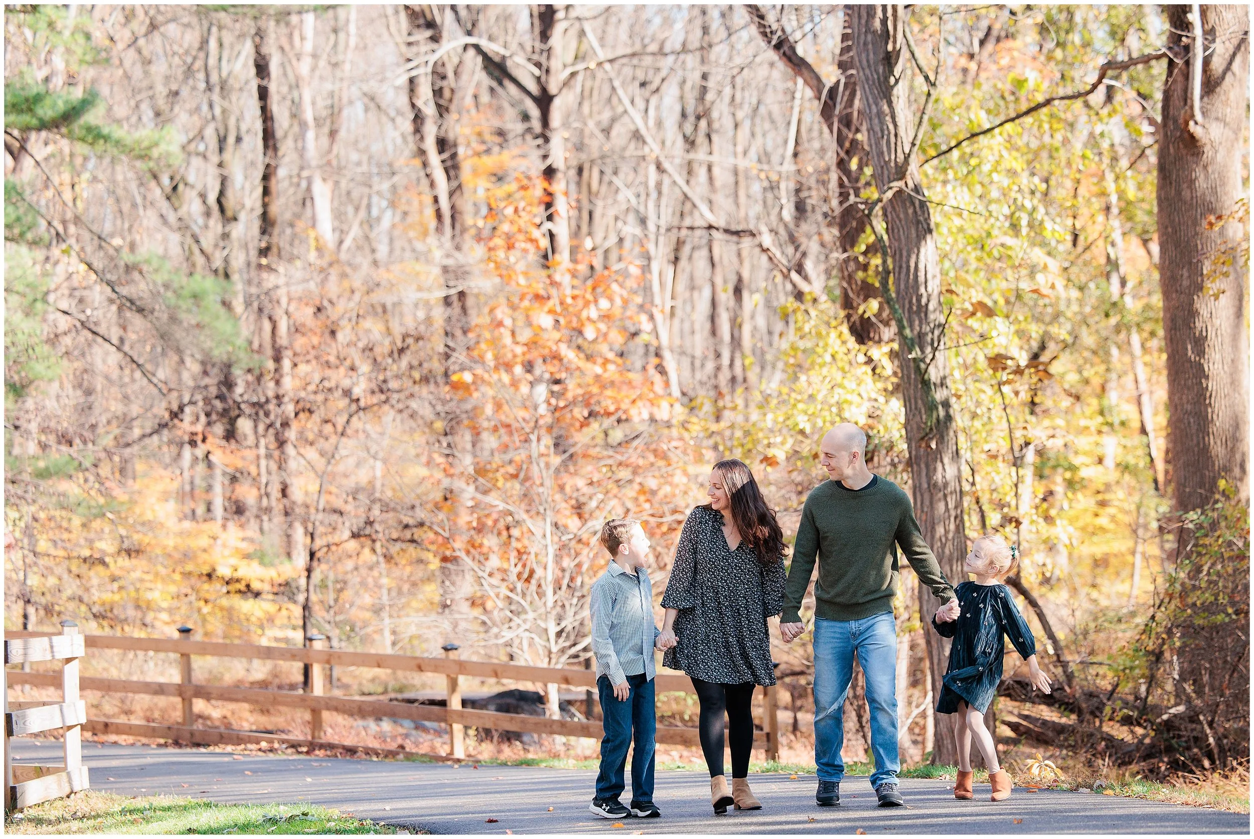 family walking in the fall foliage during fall family session in Wheaton Maryland