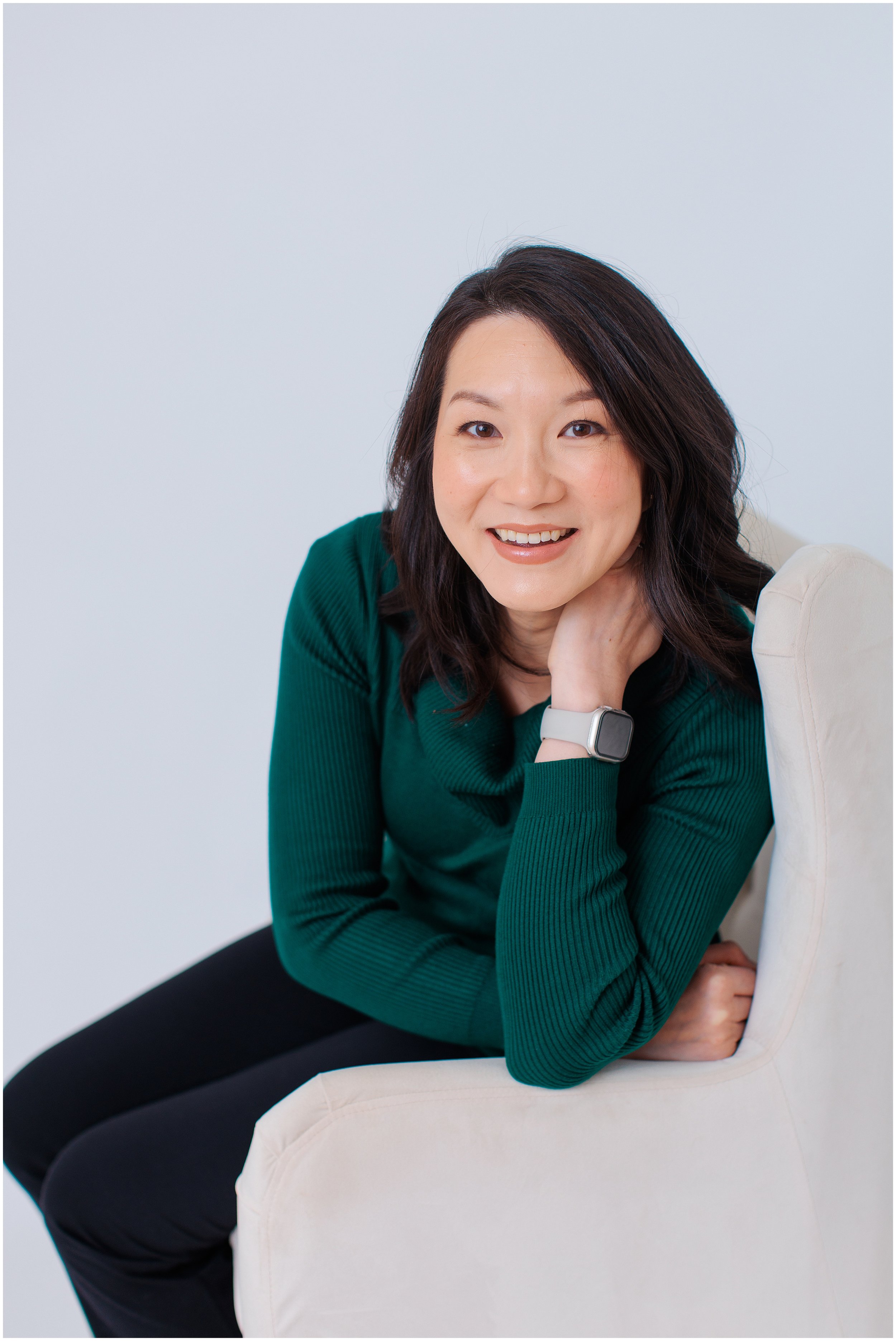  Professional headshot of a woman in a green sweater photographed in my natural light Silver Spring MD studio 