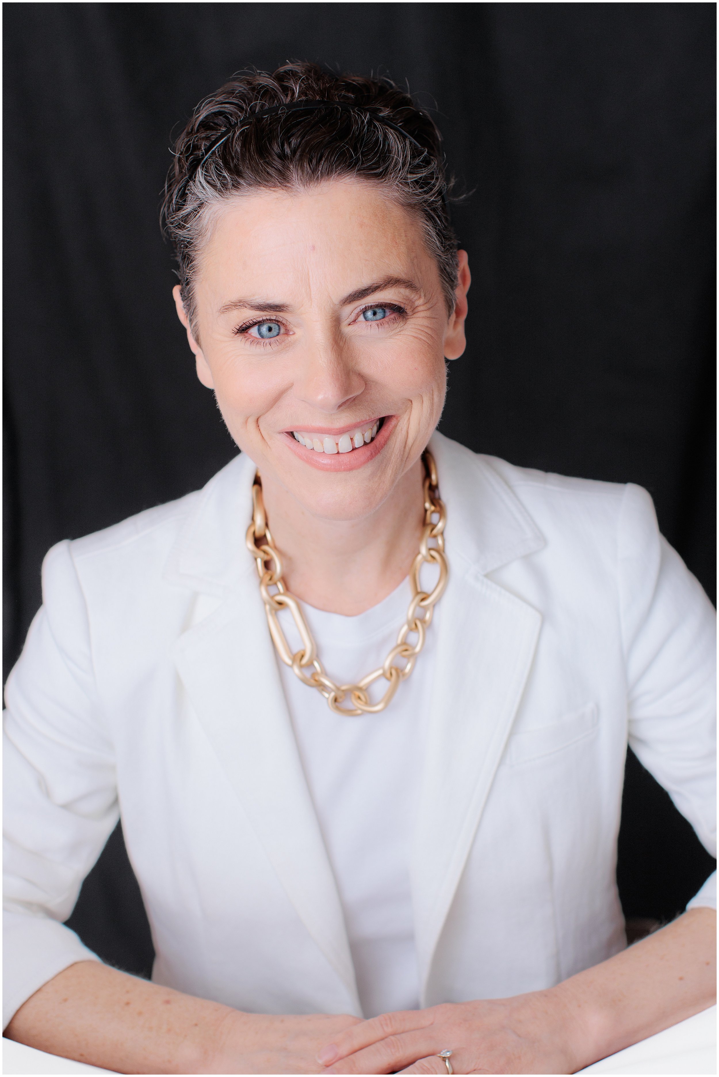  Studio headshot of a professional woman in a white blazer photographed in Silver Spring Maryland 