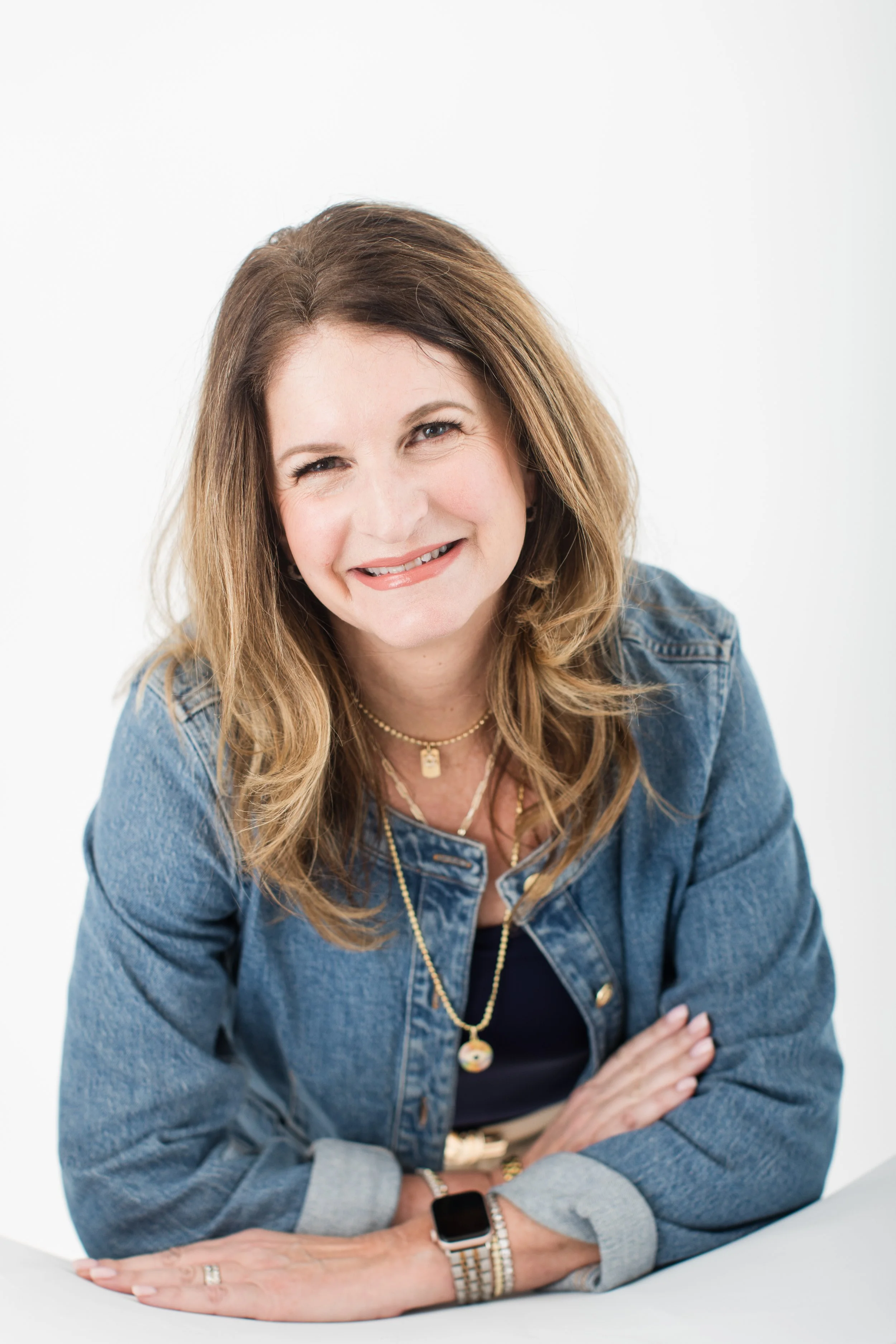  Approachable headshot of a woman in a denim jacket photographed in natural light in Silver Spring MD 