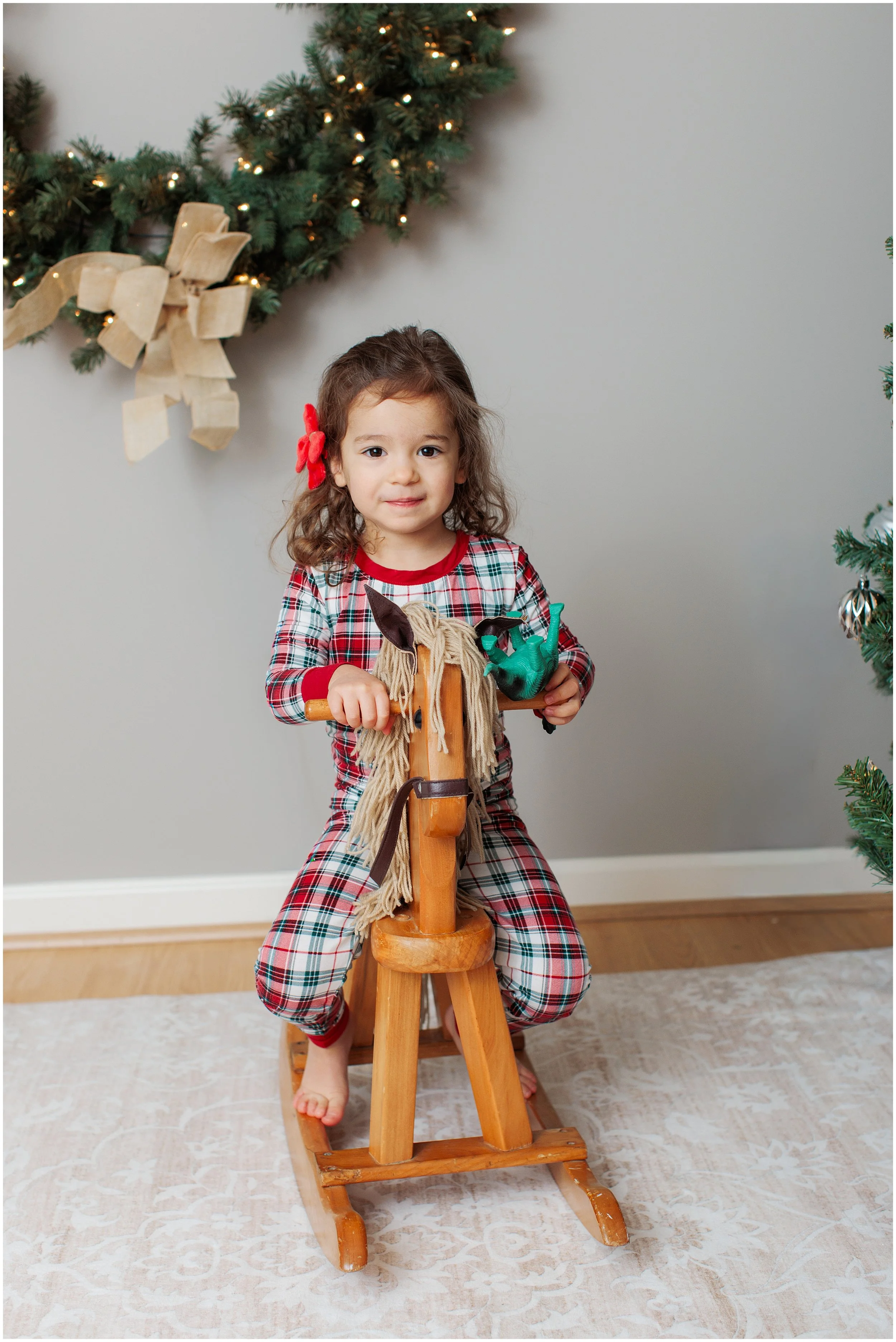 Little Girl on Rocking horse in a christmas themed studio