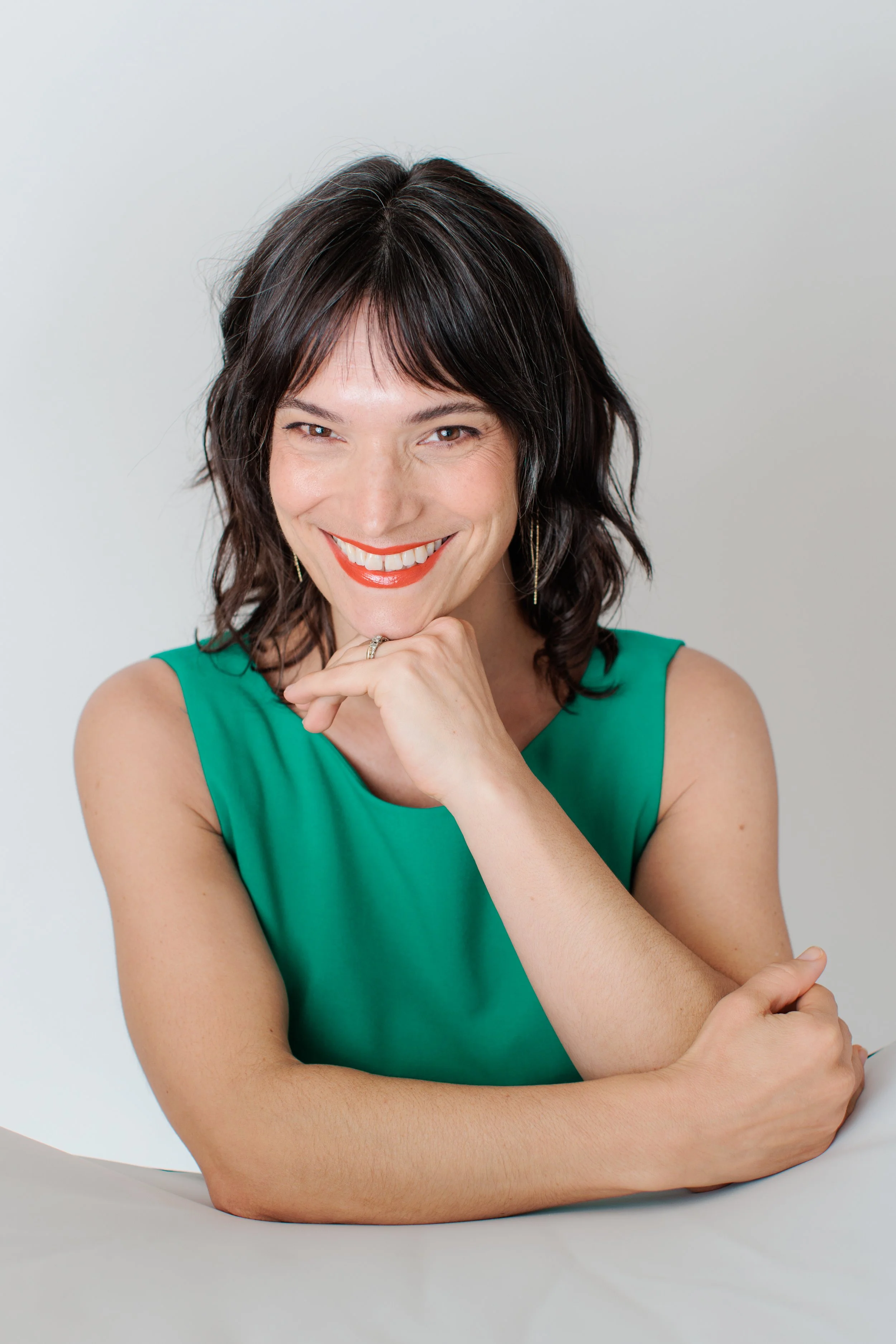 woman in green dress looking at camera