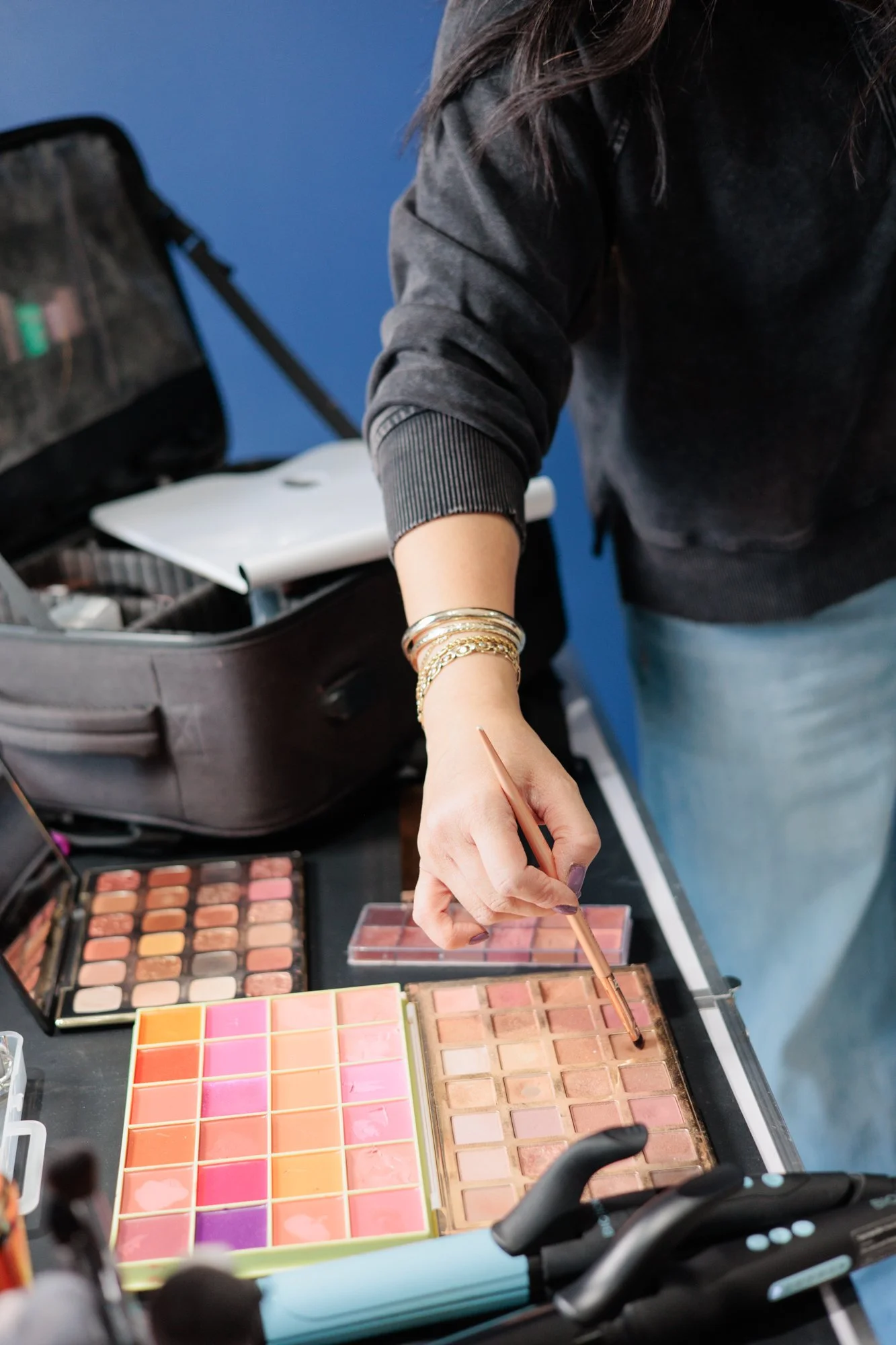  makeup artist getting makeup on brush 