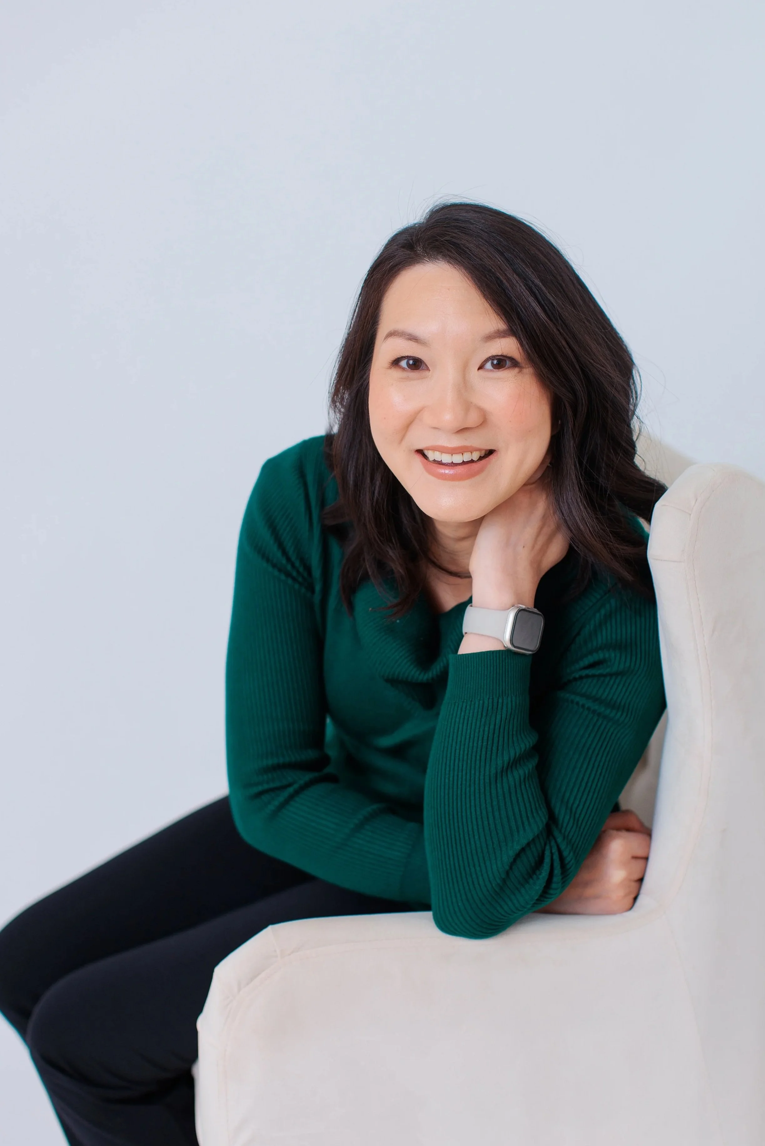  Professional headshot of a woman in a green sweater photographed in my natural light Silver Spring MD studio 