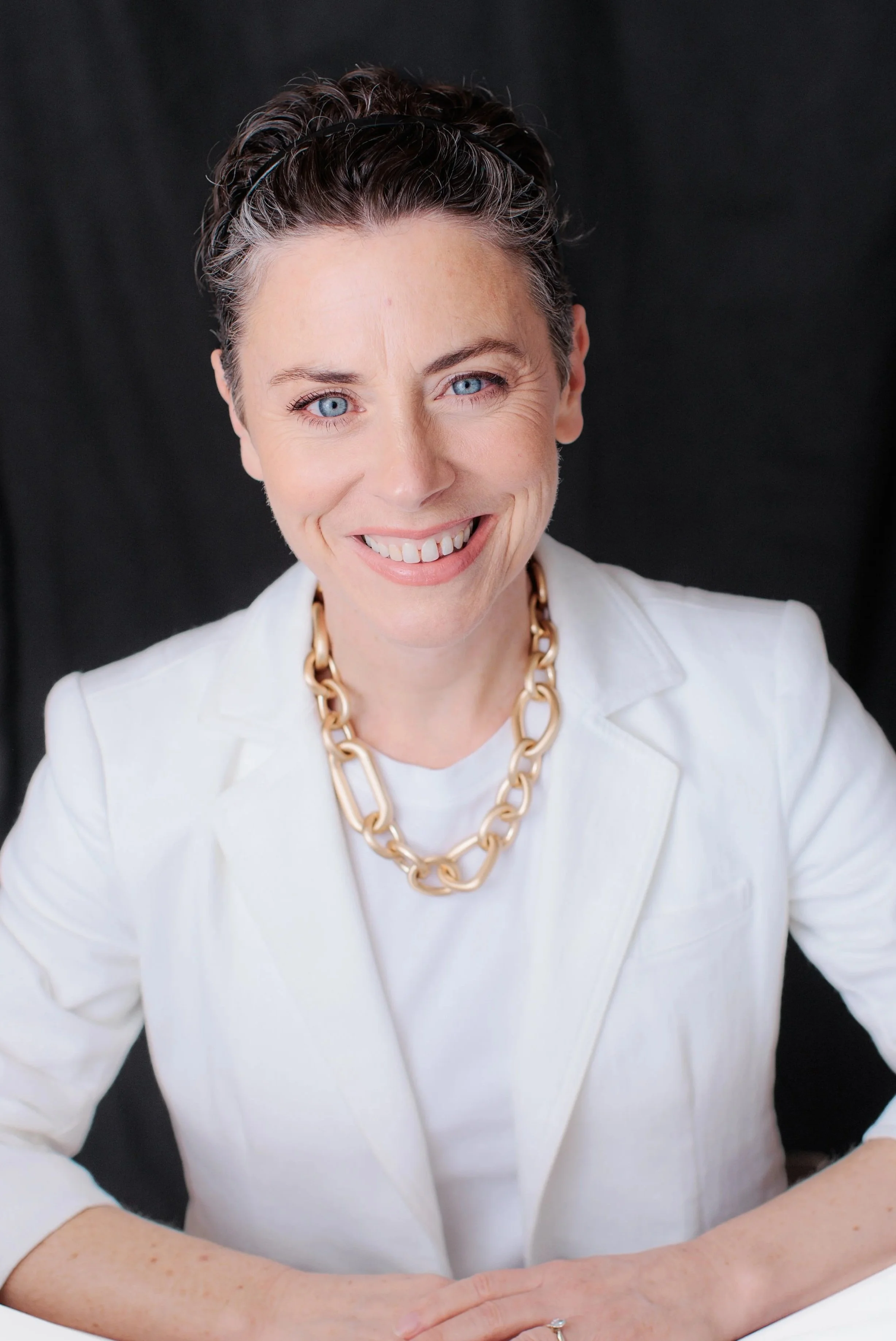  Studio headshot of a professional woman in a white blazer photographed in Silver Spring Maryland 