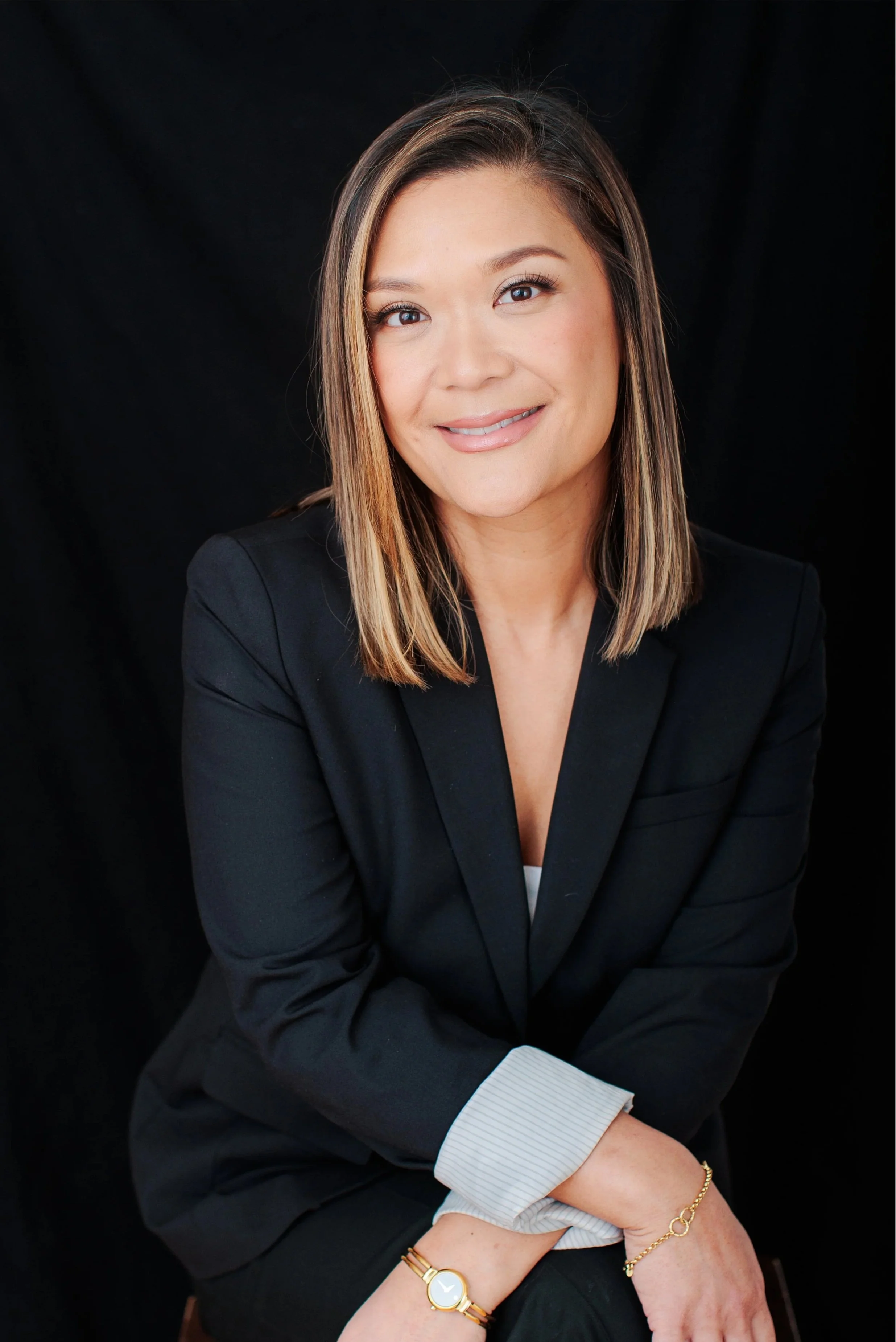  Professional studio headshot of a woman in a black blazer photographed in Silver Spring Maryland. 