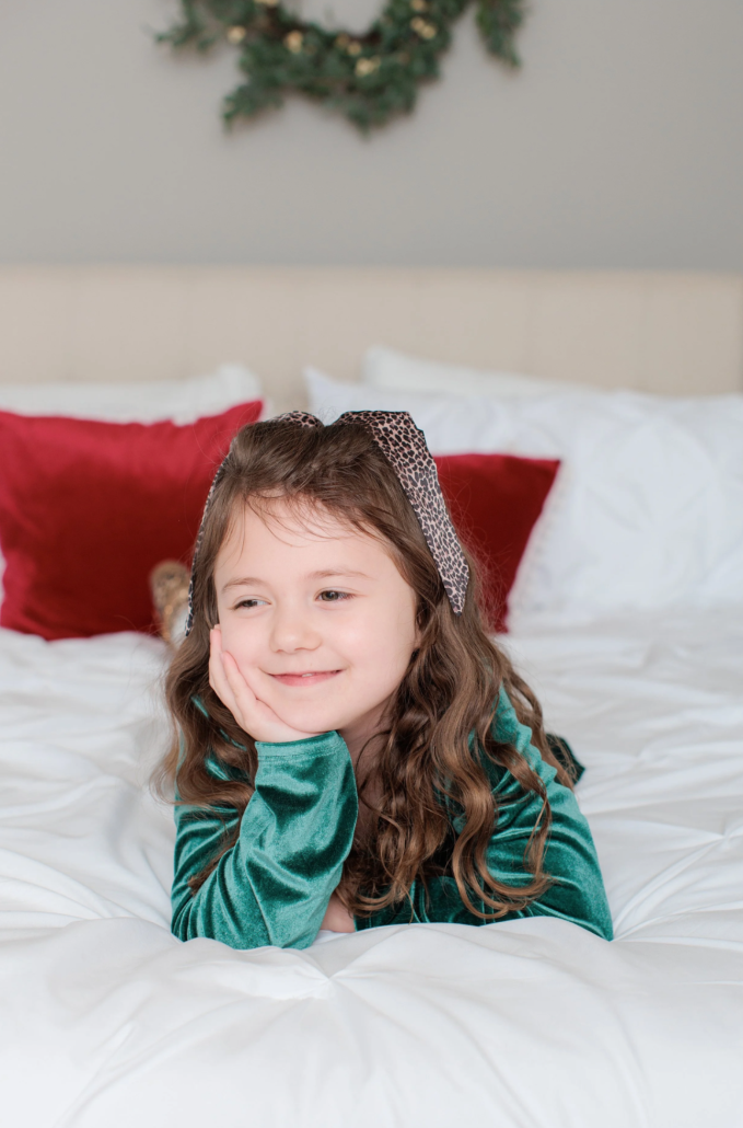 girl sitting on bed during holiday studio session