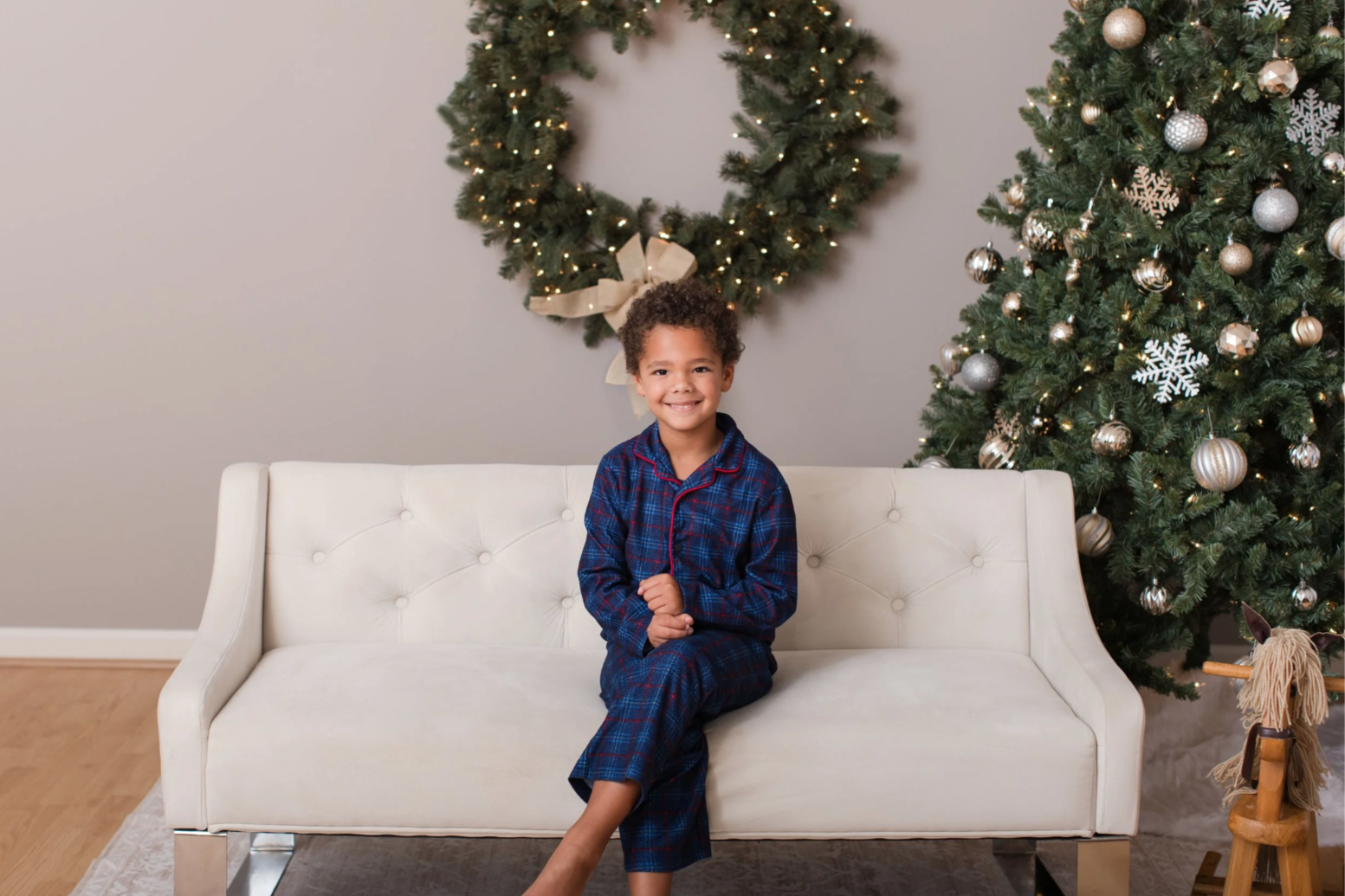 Little boy sitting on couch for Christmas mini session