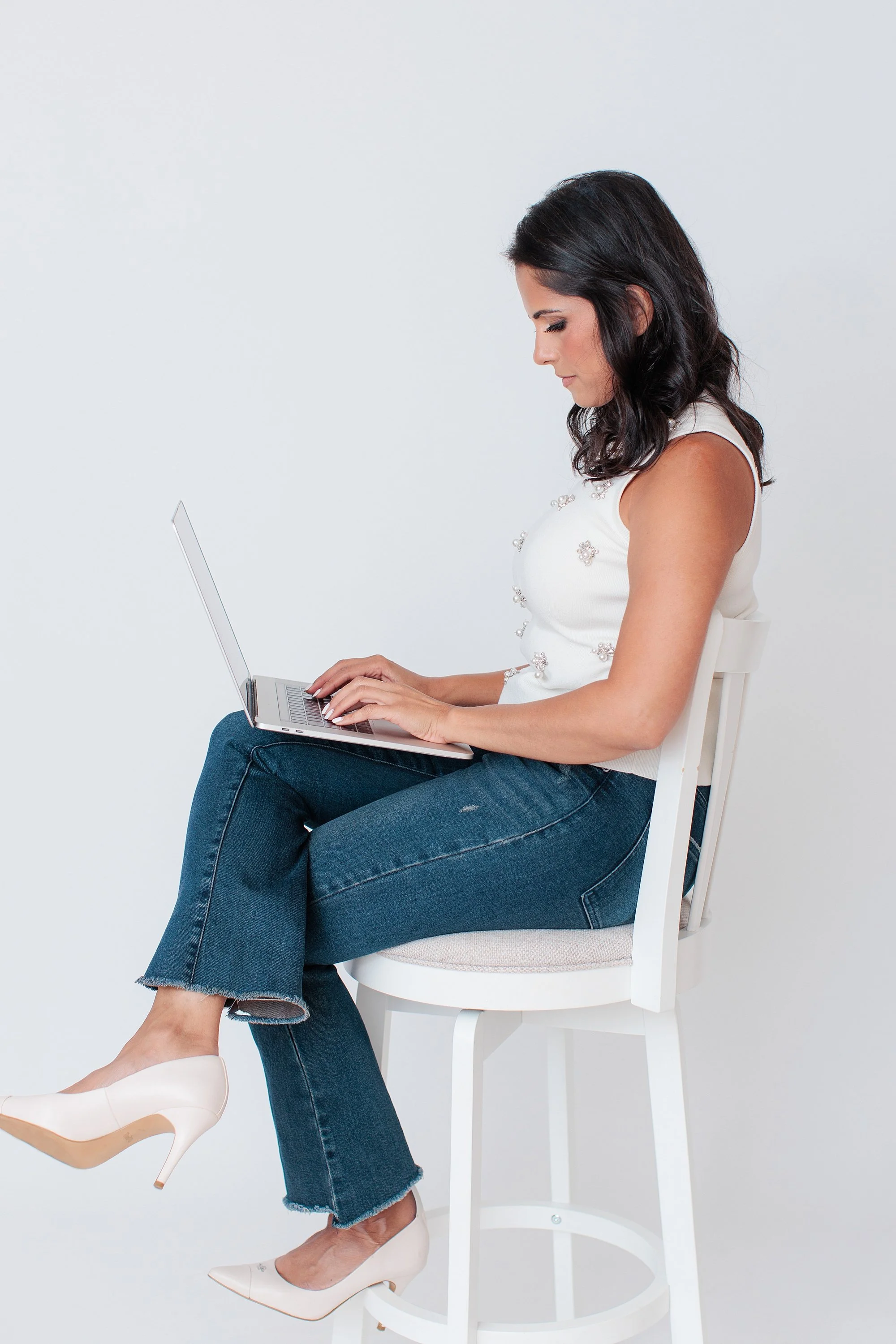 woman sitting with laptop and heels
