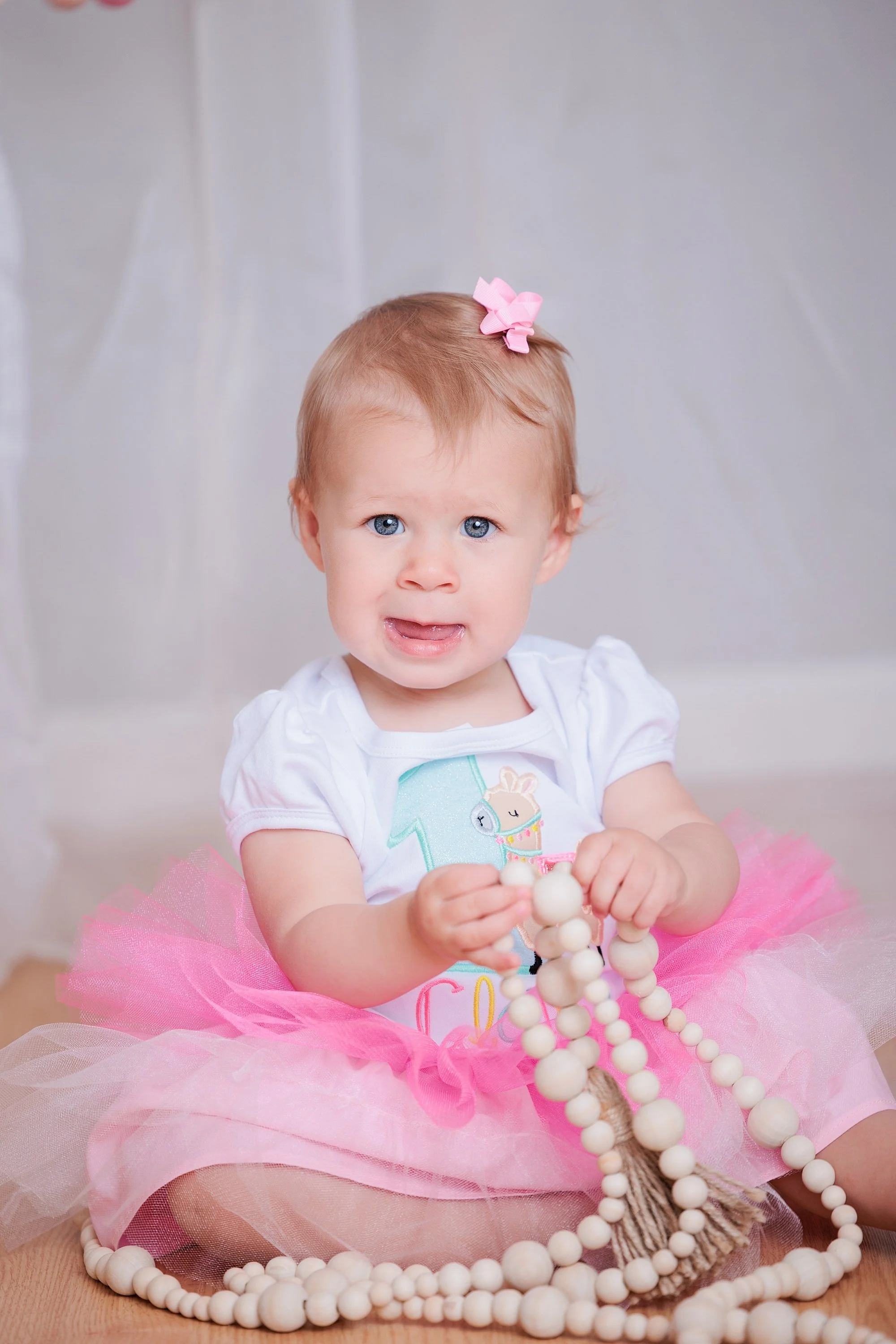 little girl with beads during studio family photo session in Silver Spring MD