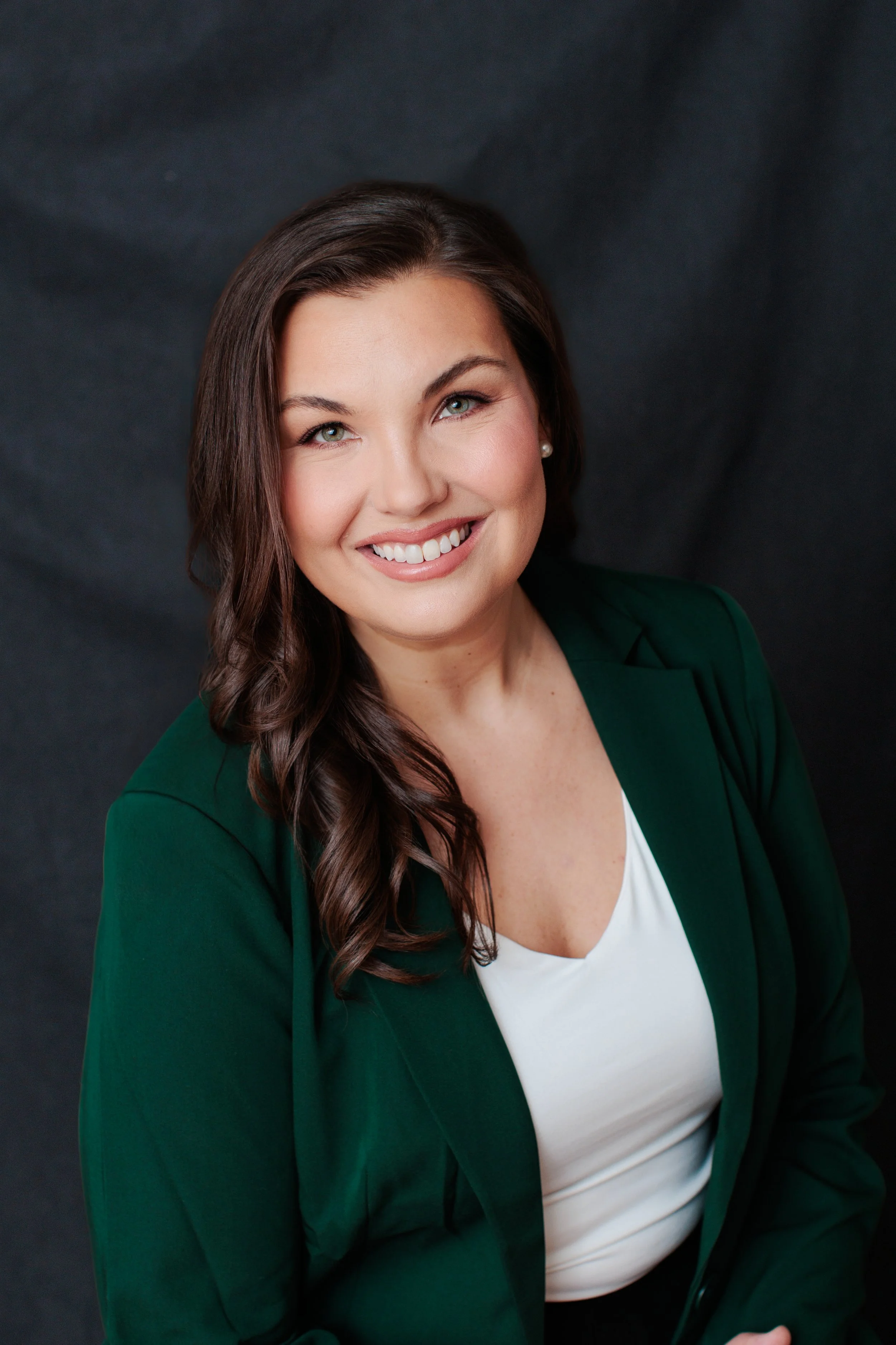 Not an AI image headshot of a woman with black background