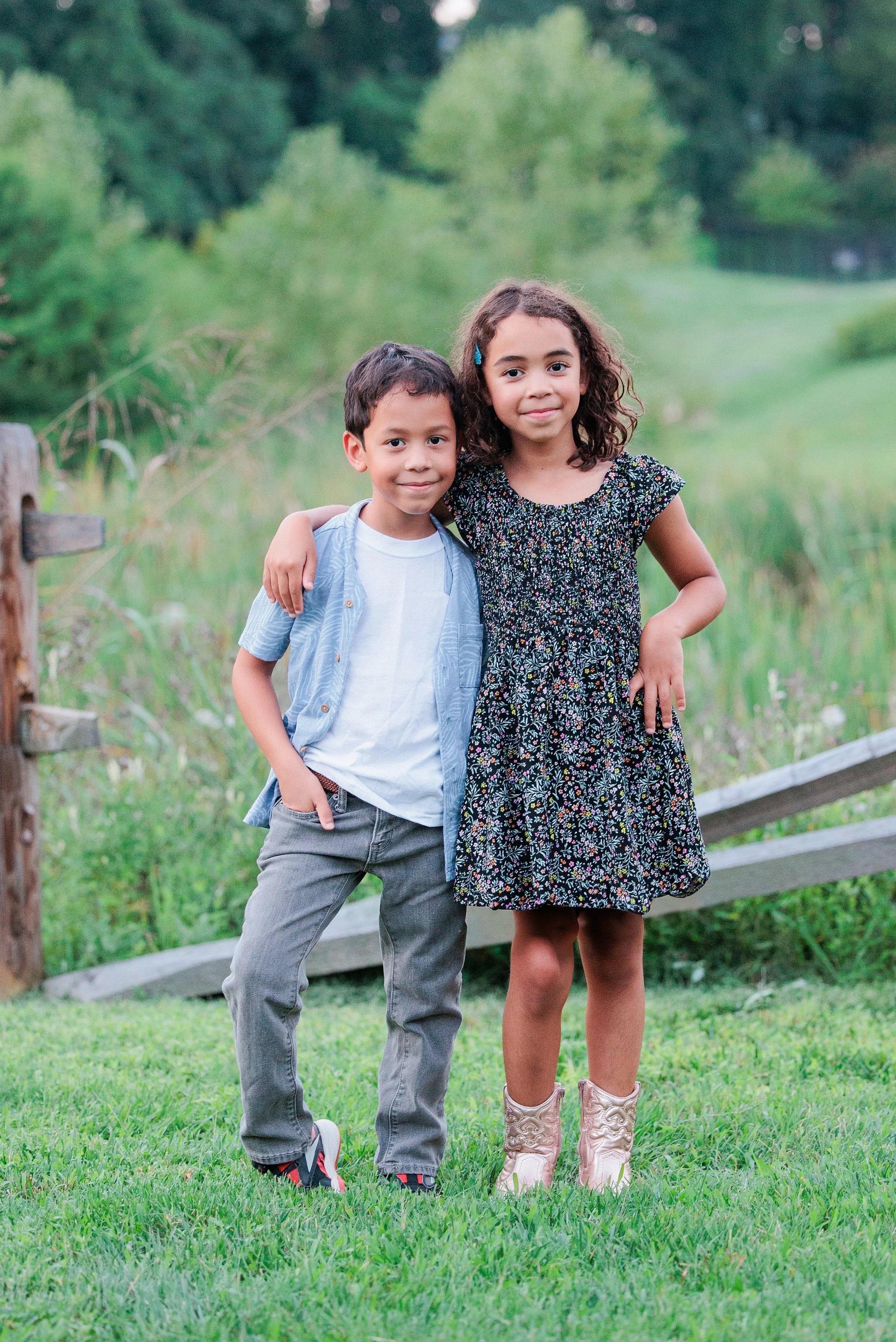 brother and sister posing for family photo in maryland
