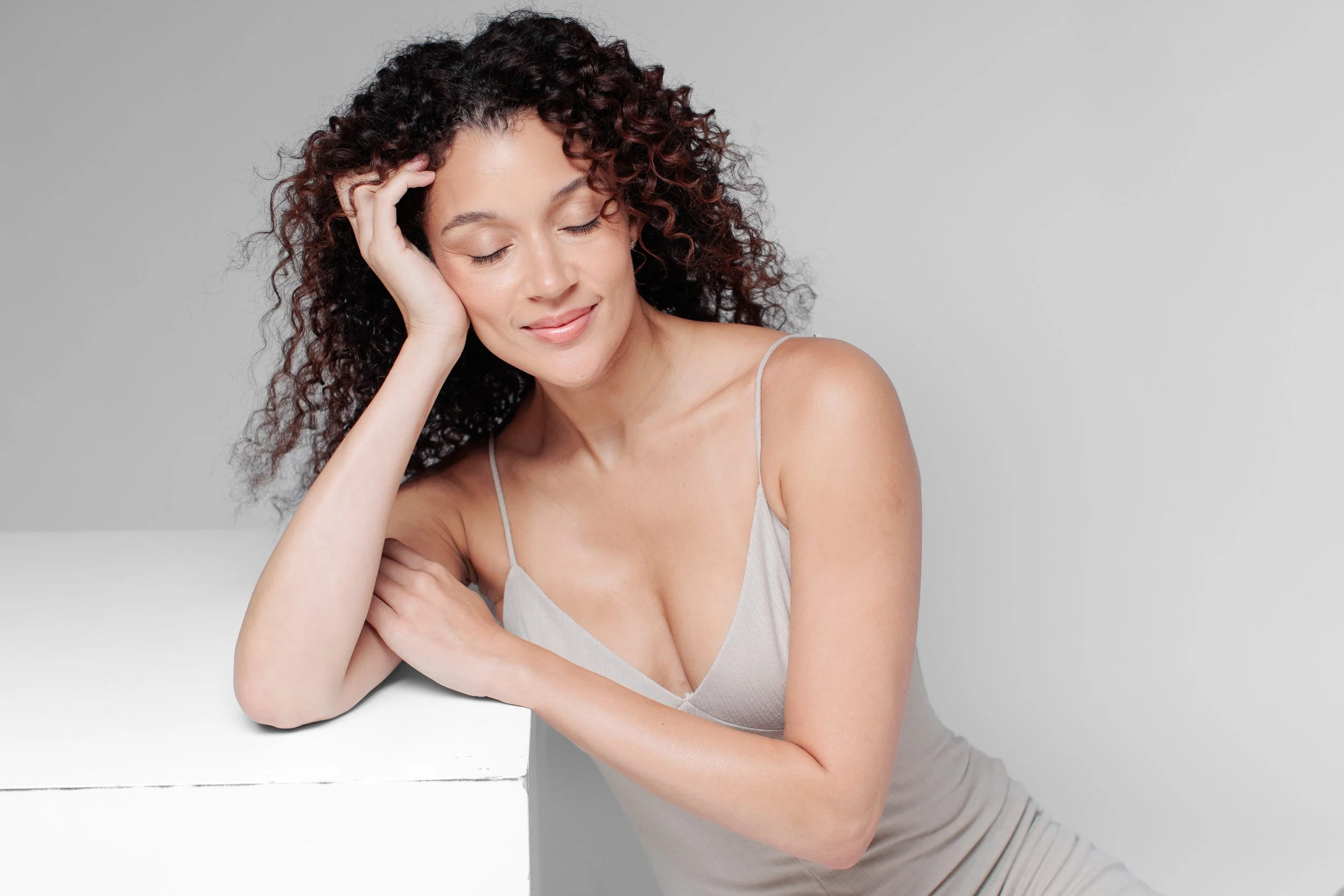 woman smiling softly with eyes closed for model photoshoot in Maryland