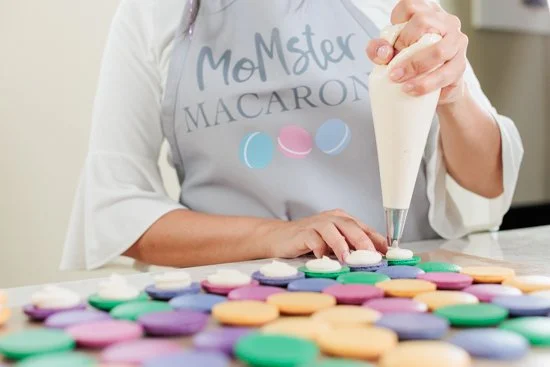 baker making macarons in her home bakery
