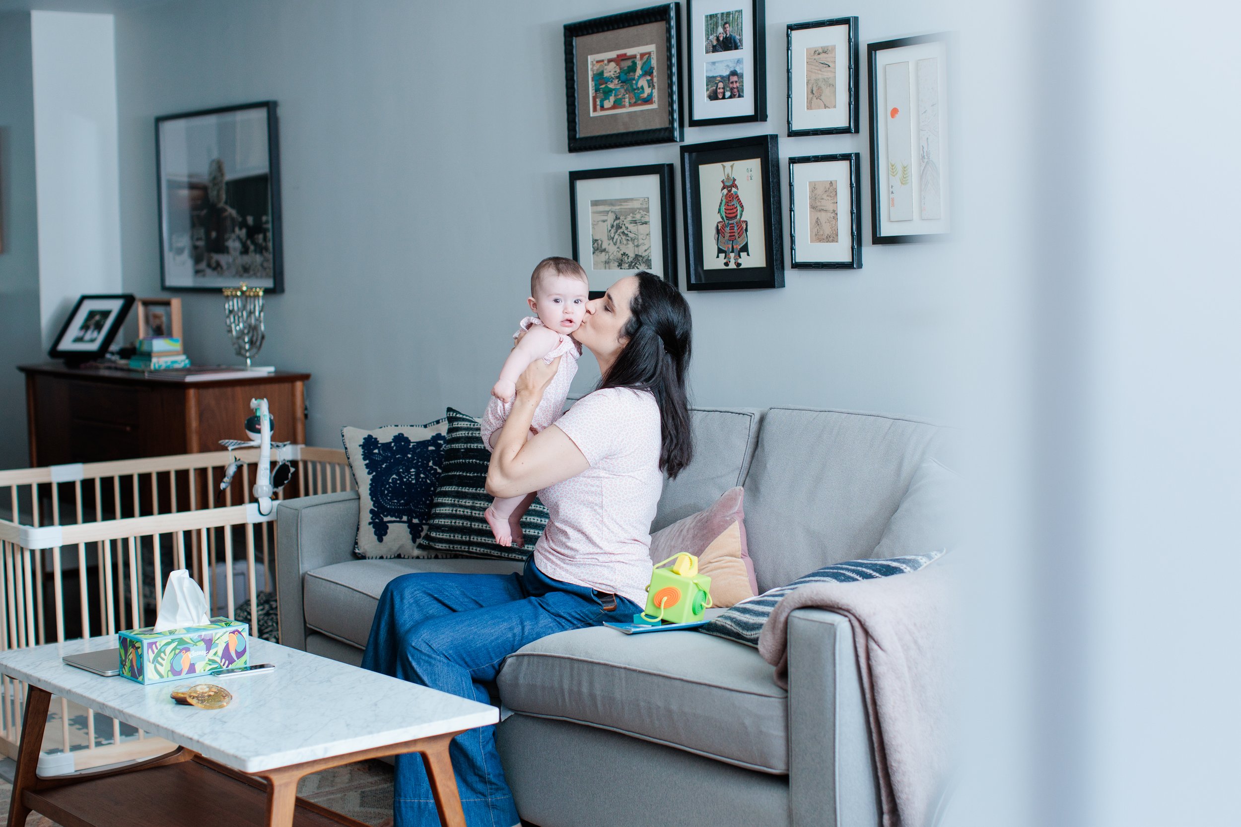 candid moment of mom and 6 month old daughter at home