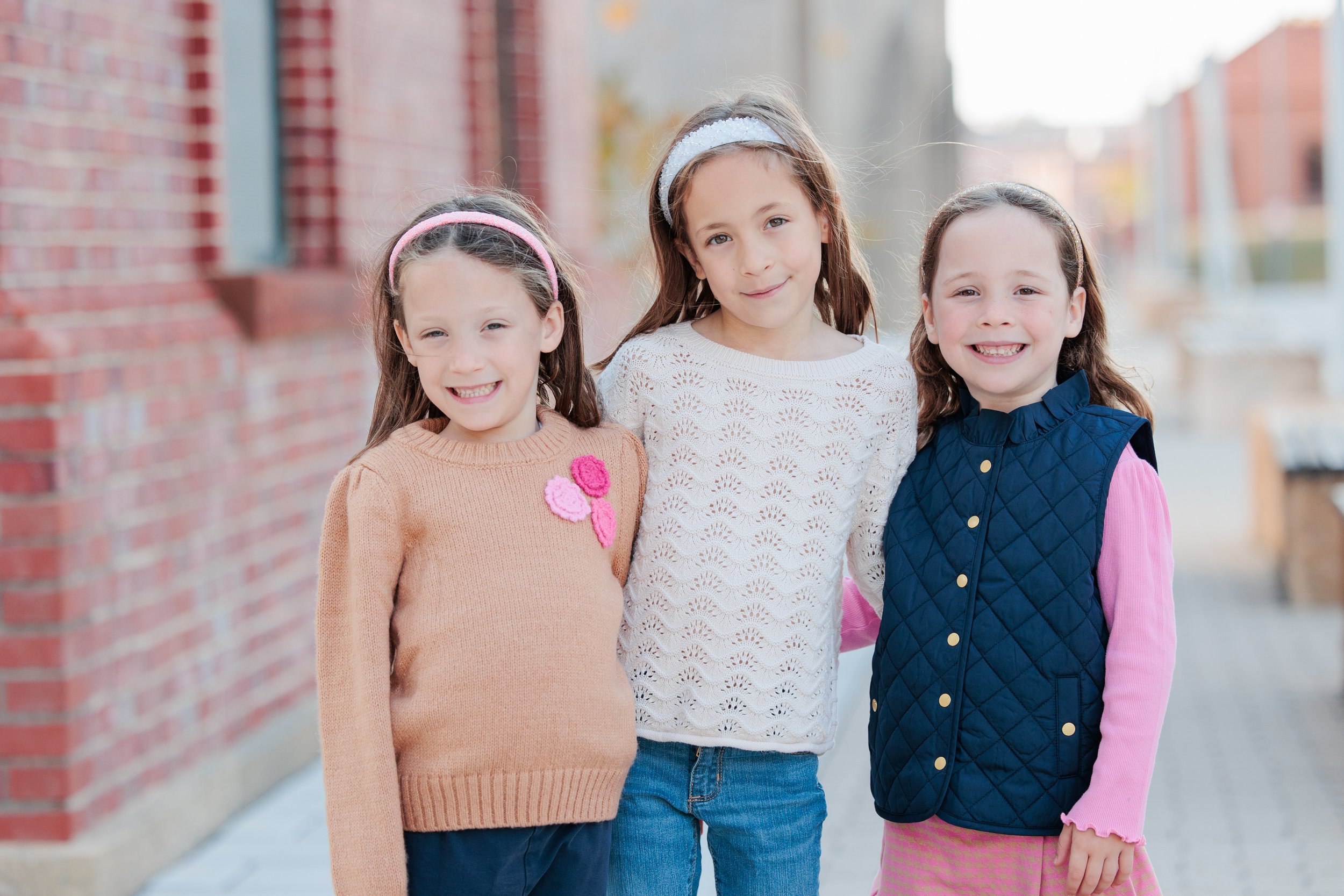 Three girls smiling during a natural light portrait session in Washington DC