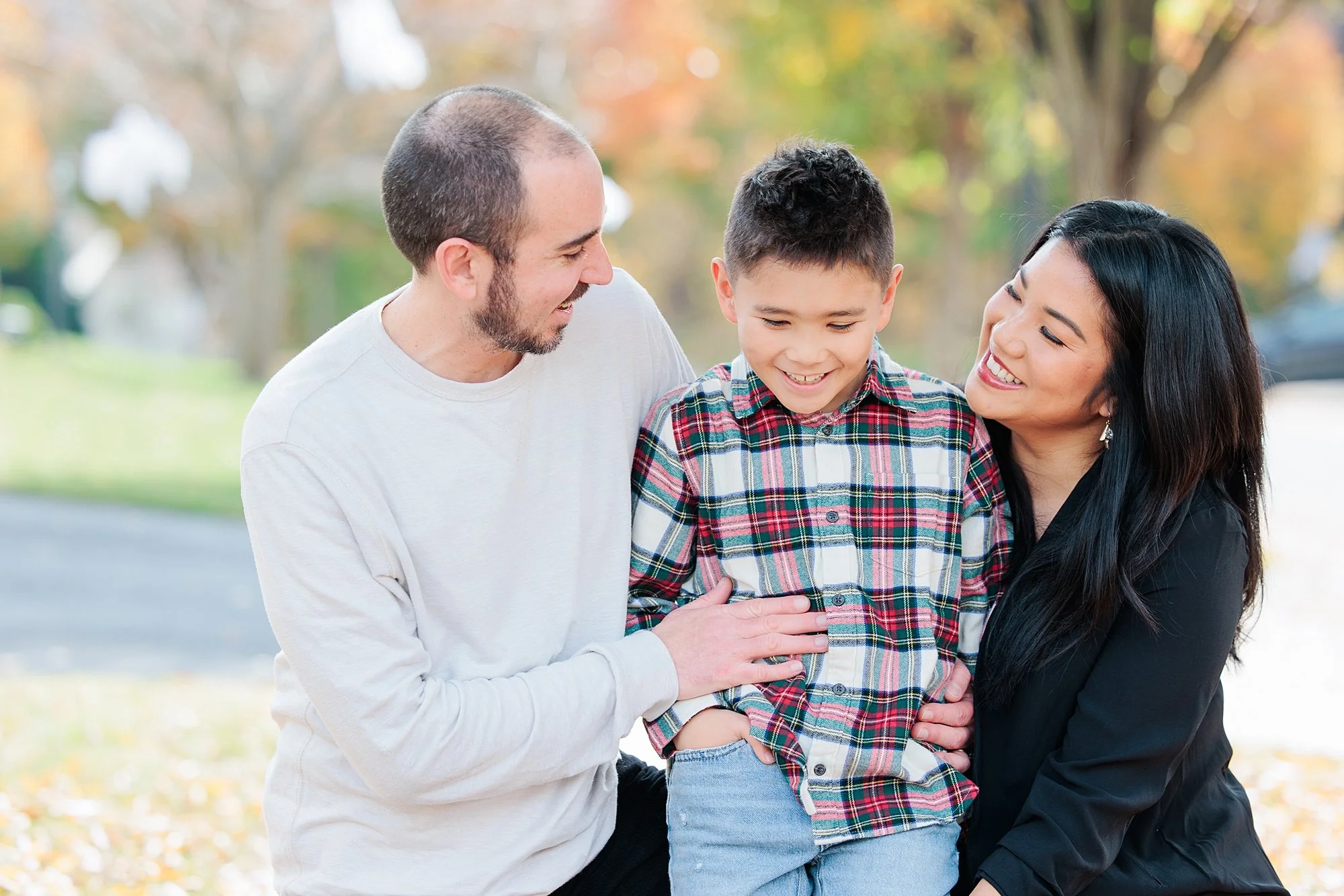 family smiling outside for family photo session in Maryland