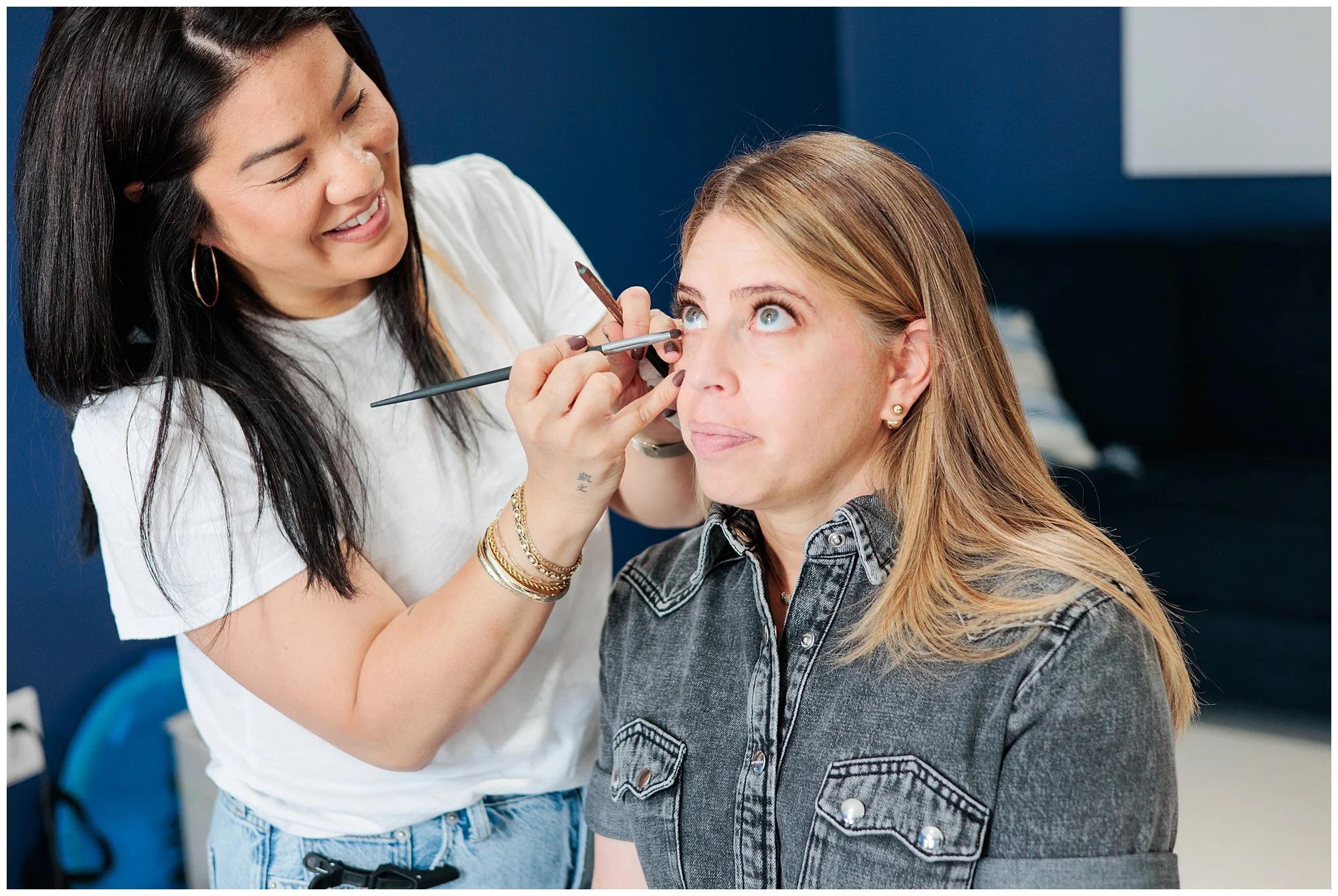 woman getting her makeup done before headshot session