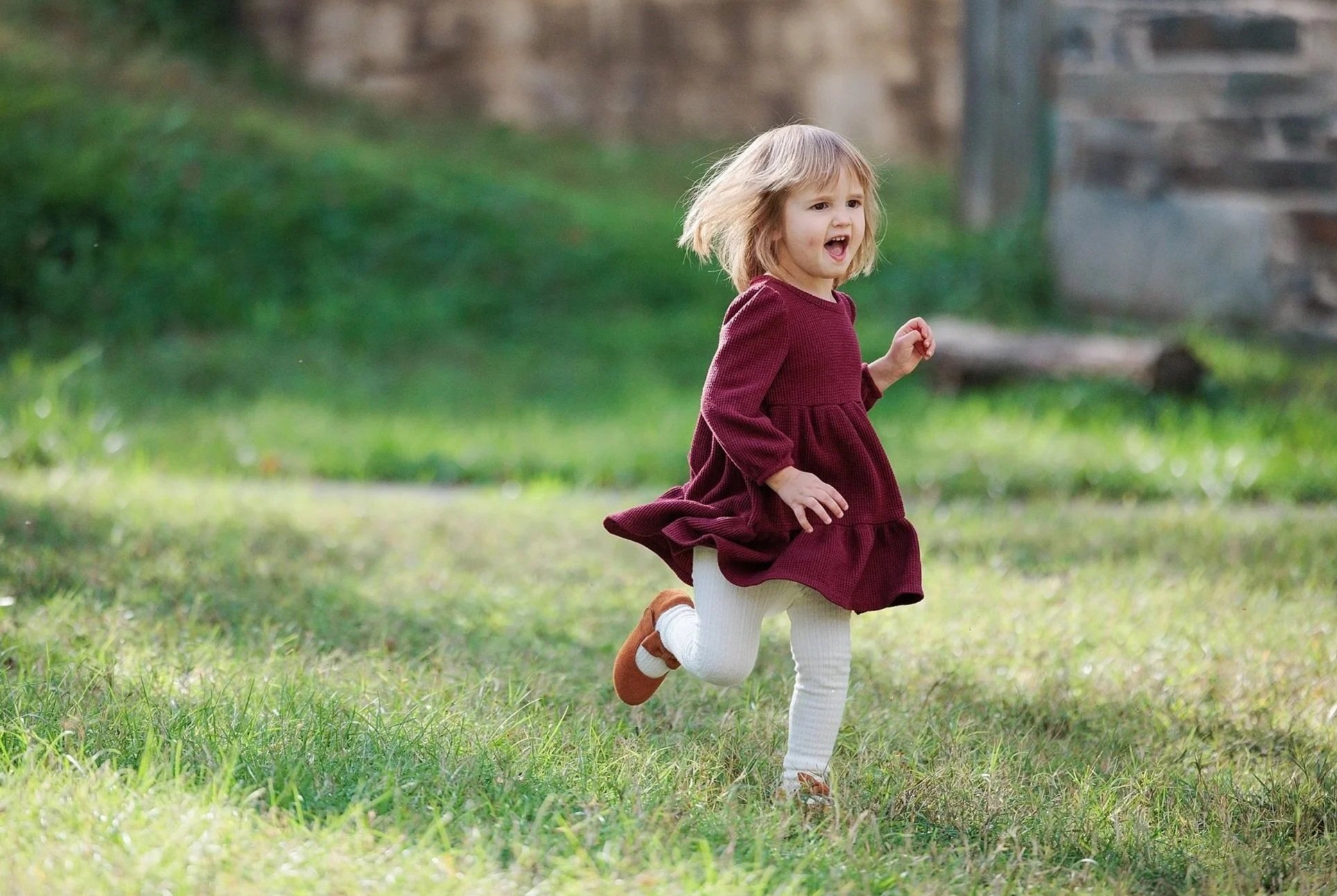 little girl running during fall family photo session in Washington DC