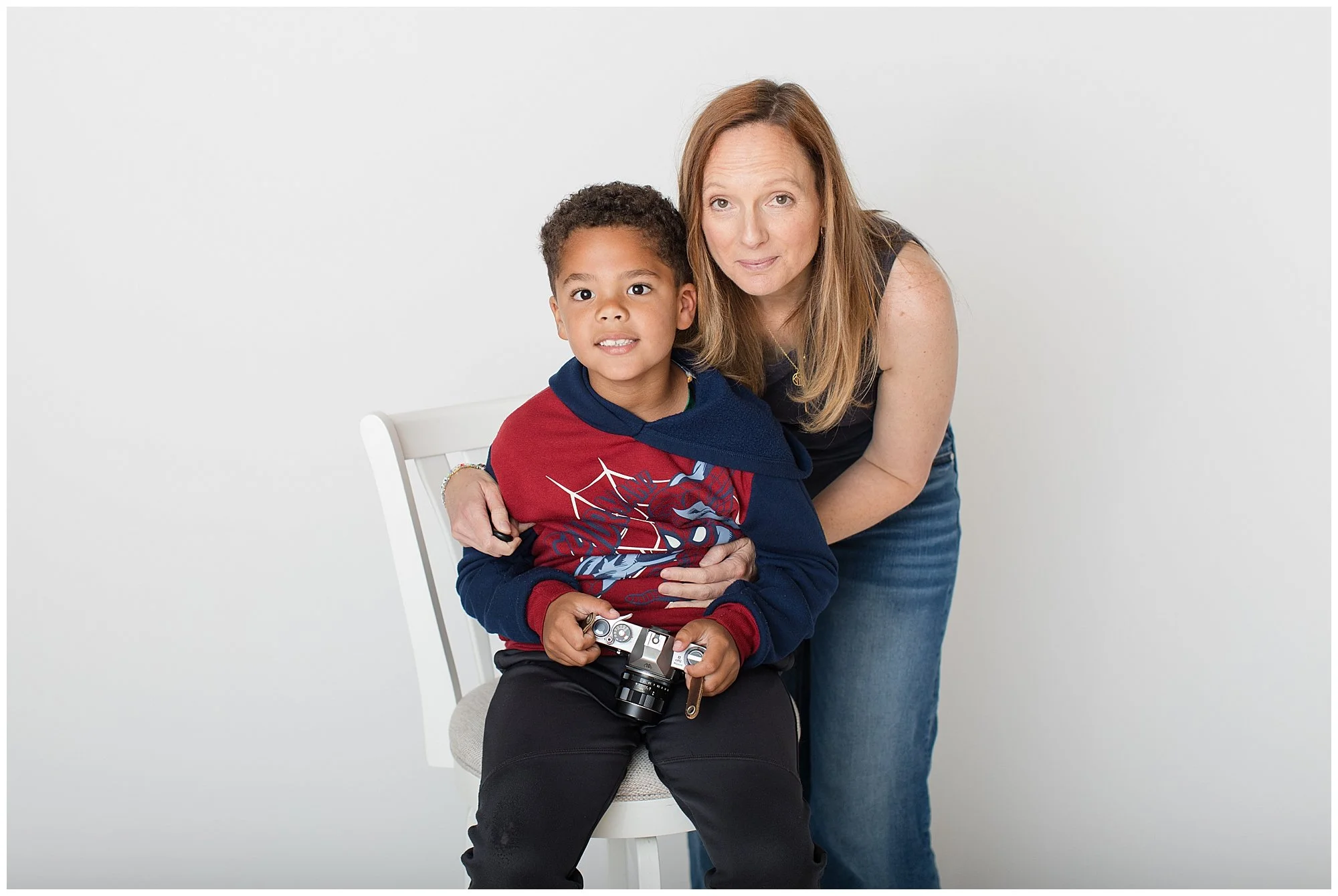 6 year old with mom during personality portrait in portrait studio in maryland