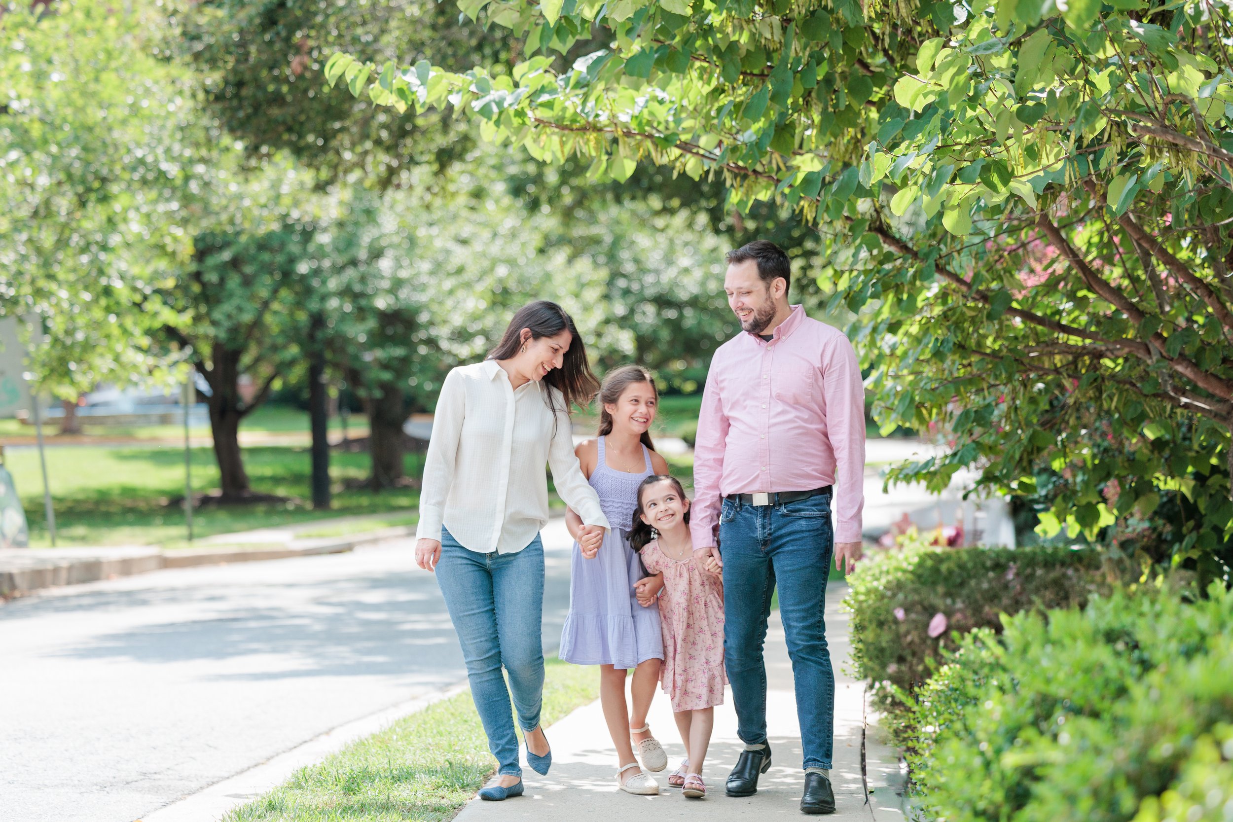family walking and holding hands in Silver Spring MD on a spring day
