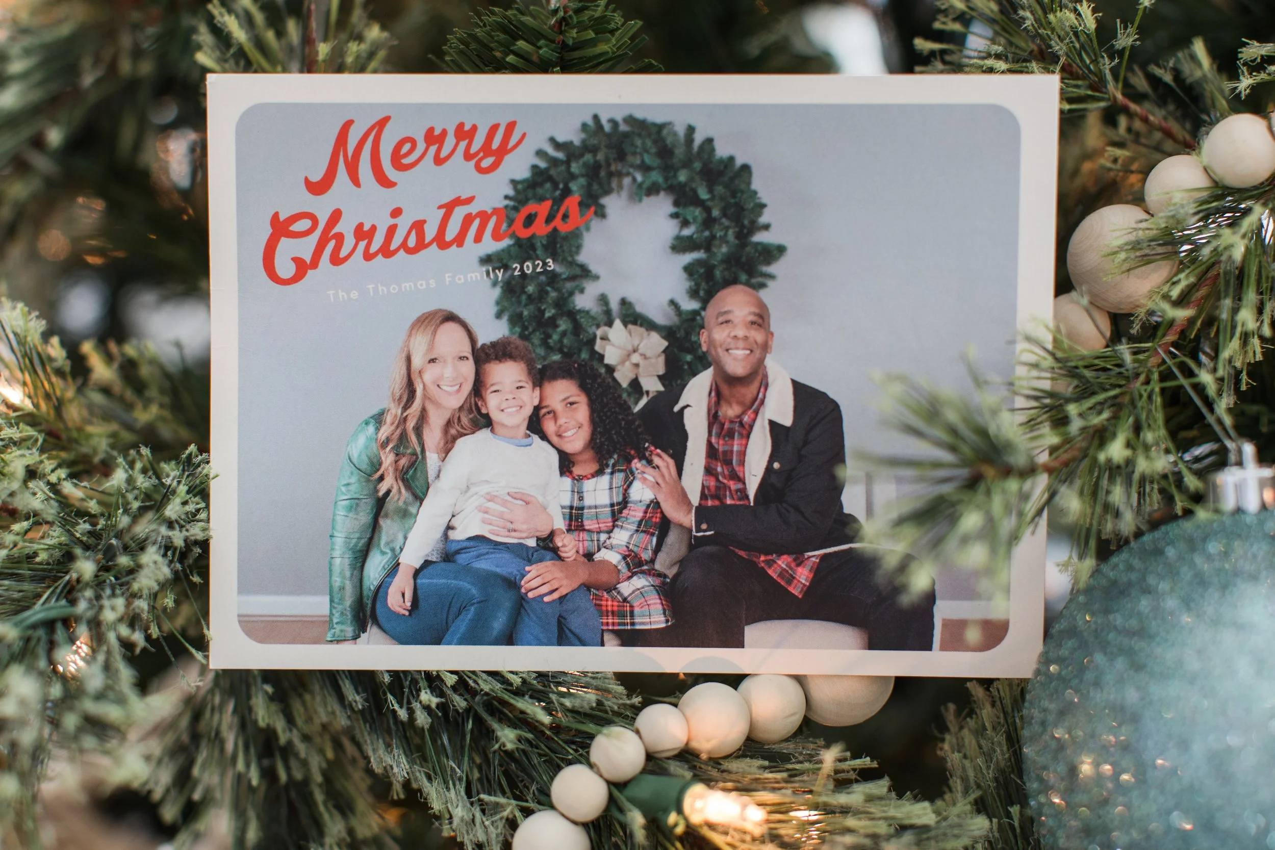 Family cuddling together for Christmas card photos