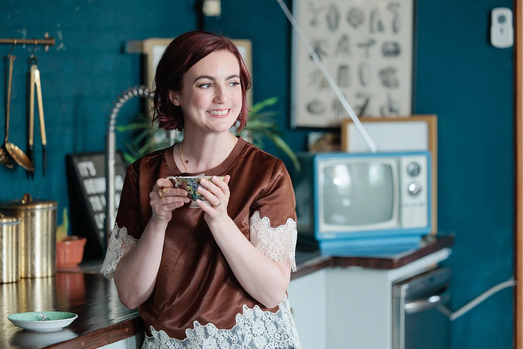 therapist sipping tea in retro Baltimore setting