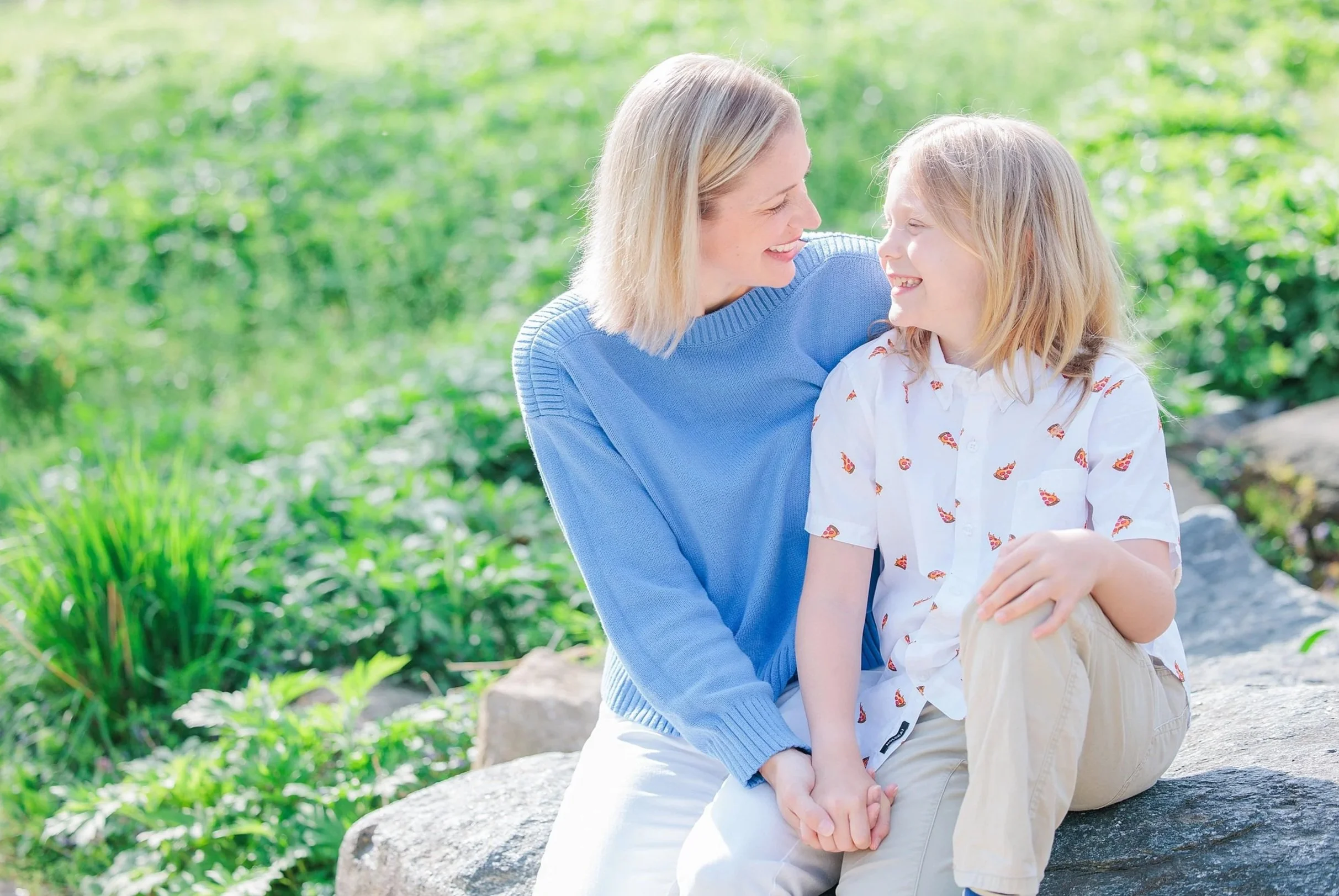 mom and son sitting on rock in Robinson nature center in maryland for family photography