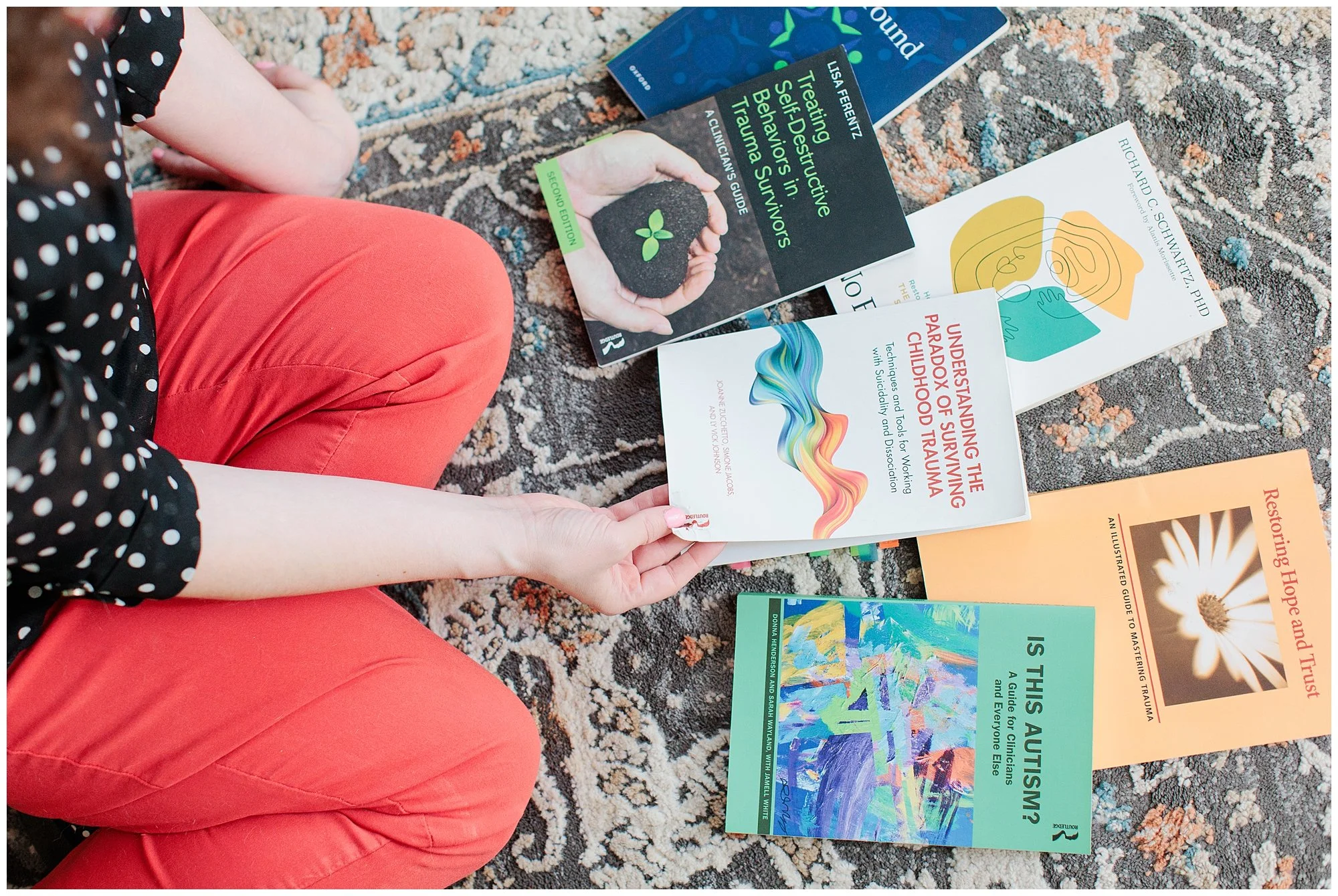 brand therapist looking at books on floor