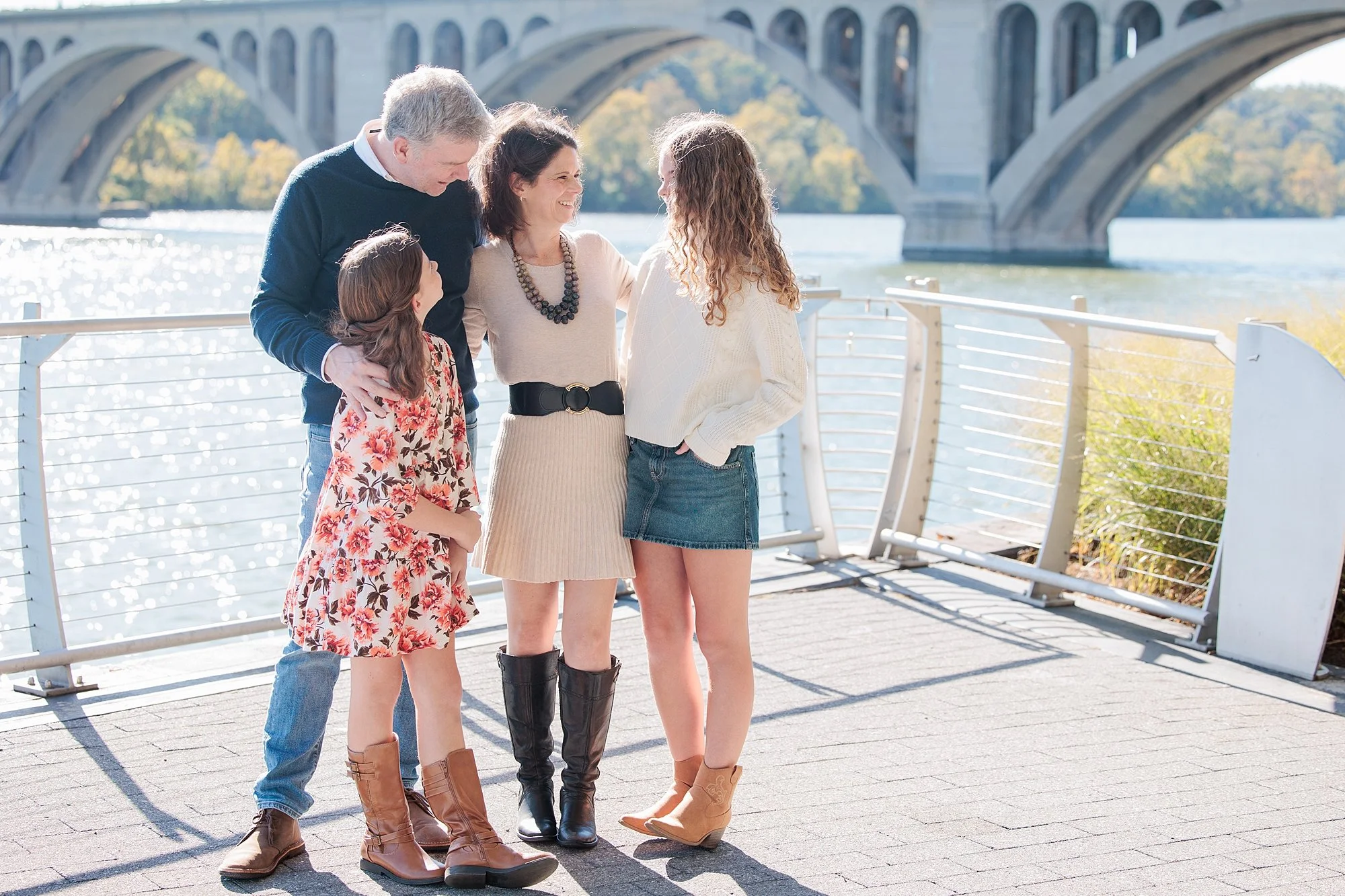 Family laughing together at Georgetown waterfront for family photos