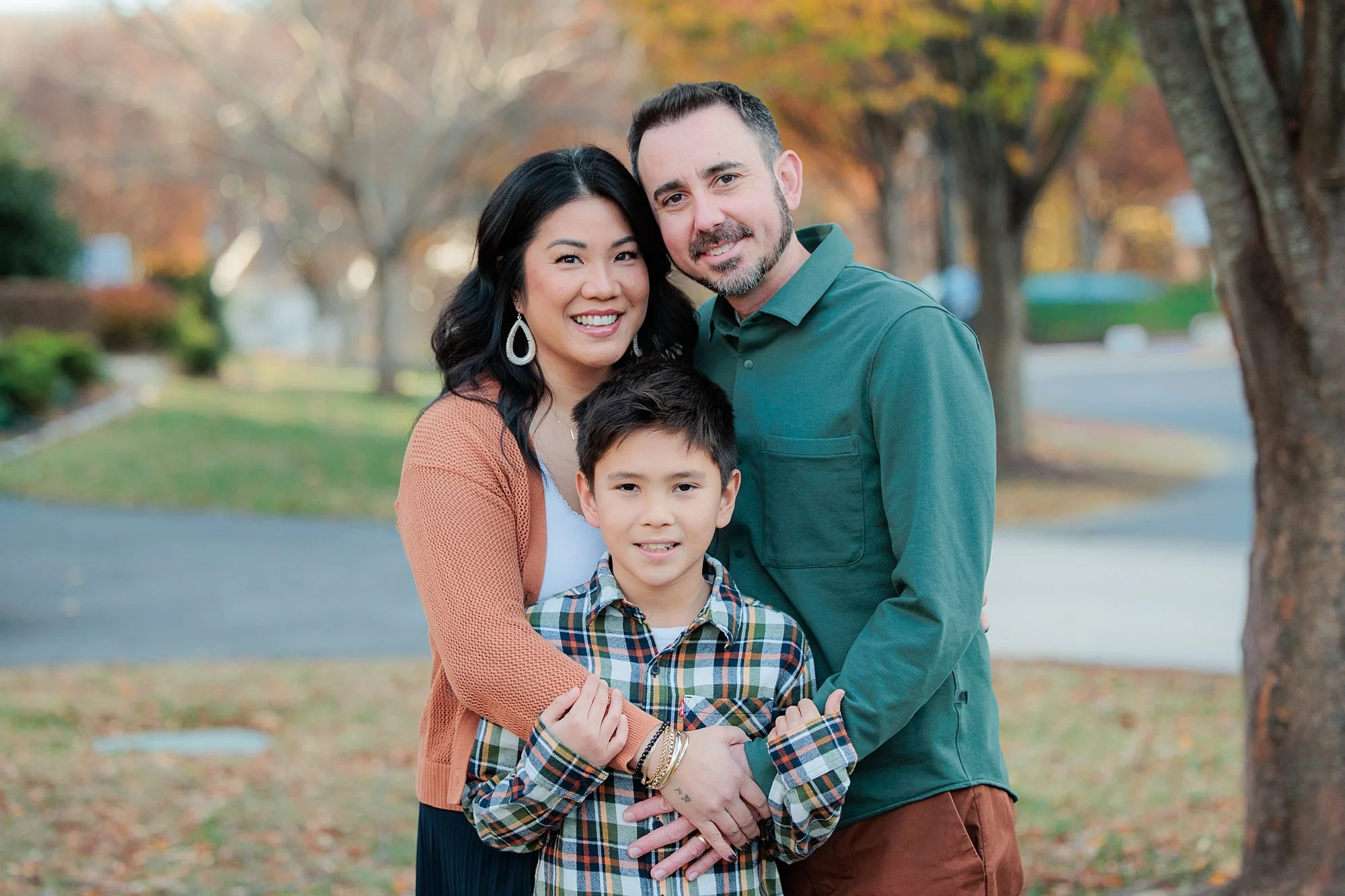 family in outdoor fall setting for family photoshoot