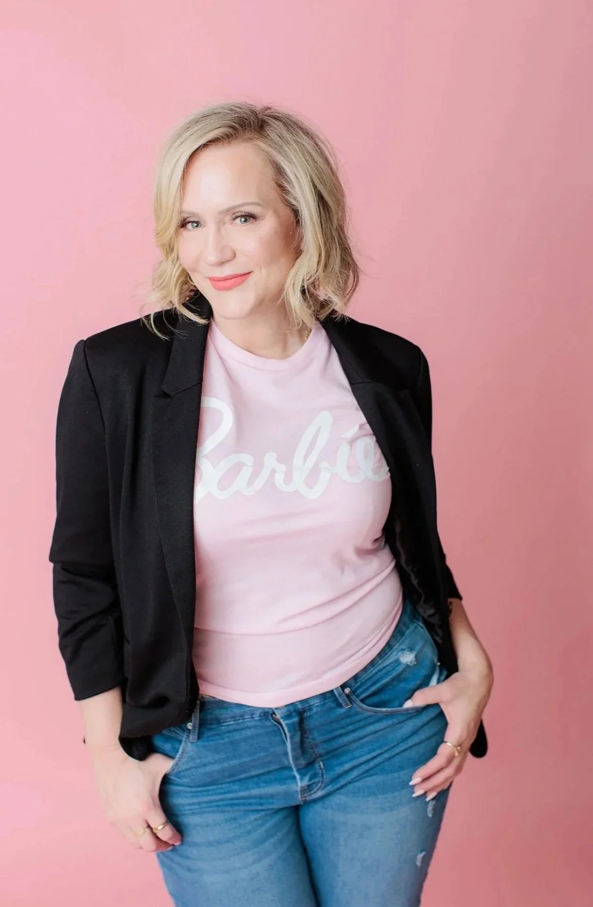 woman in Silver Spring studio posing against pink backdrop