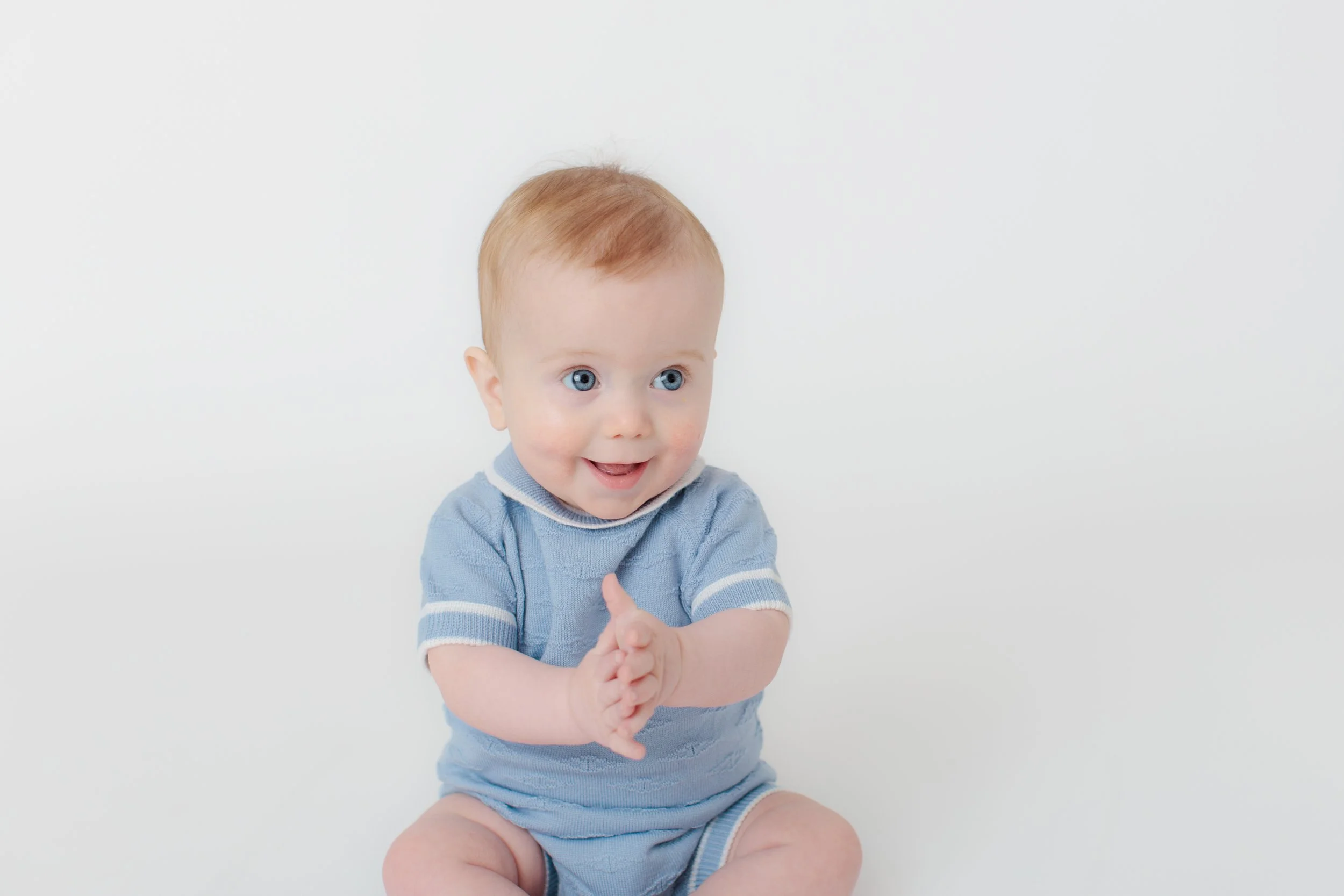 Six month old baby boy clapping happy in Silver Spring studio