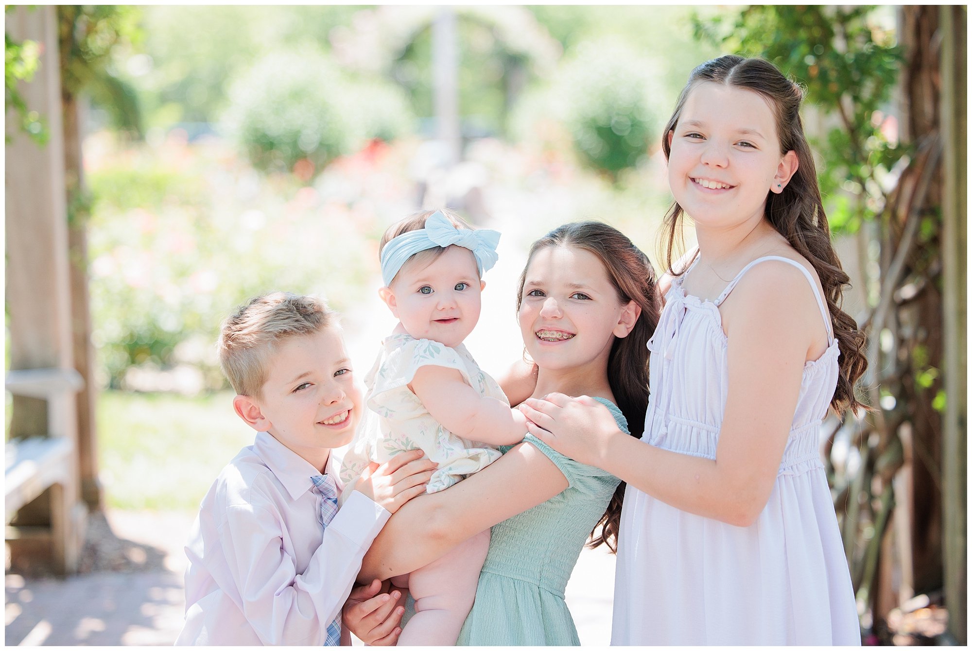 Siblings holding their baby brother in Arlington Virginia