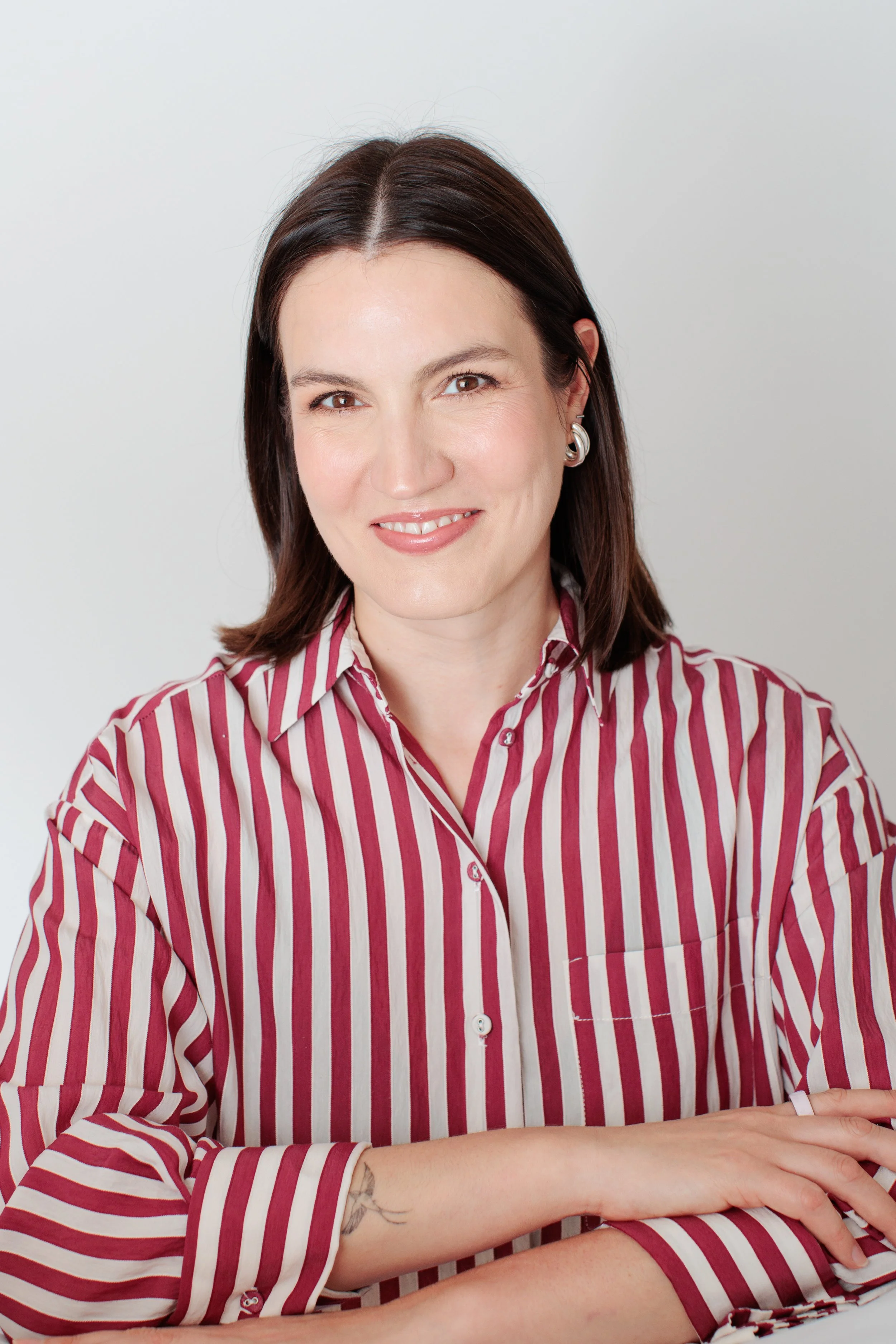 woman in striped shirt smiling for headshot in silver spring studio