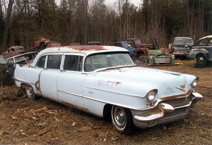 I realize that a 1956 Cadillac limousine isn't a truck, but in the back, you can see several trucks, including a decent front end of a GMC.