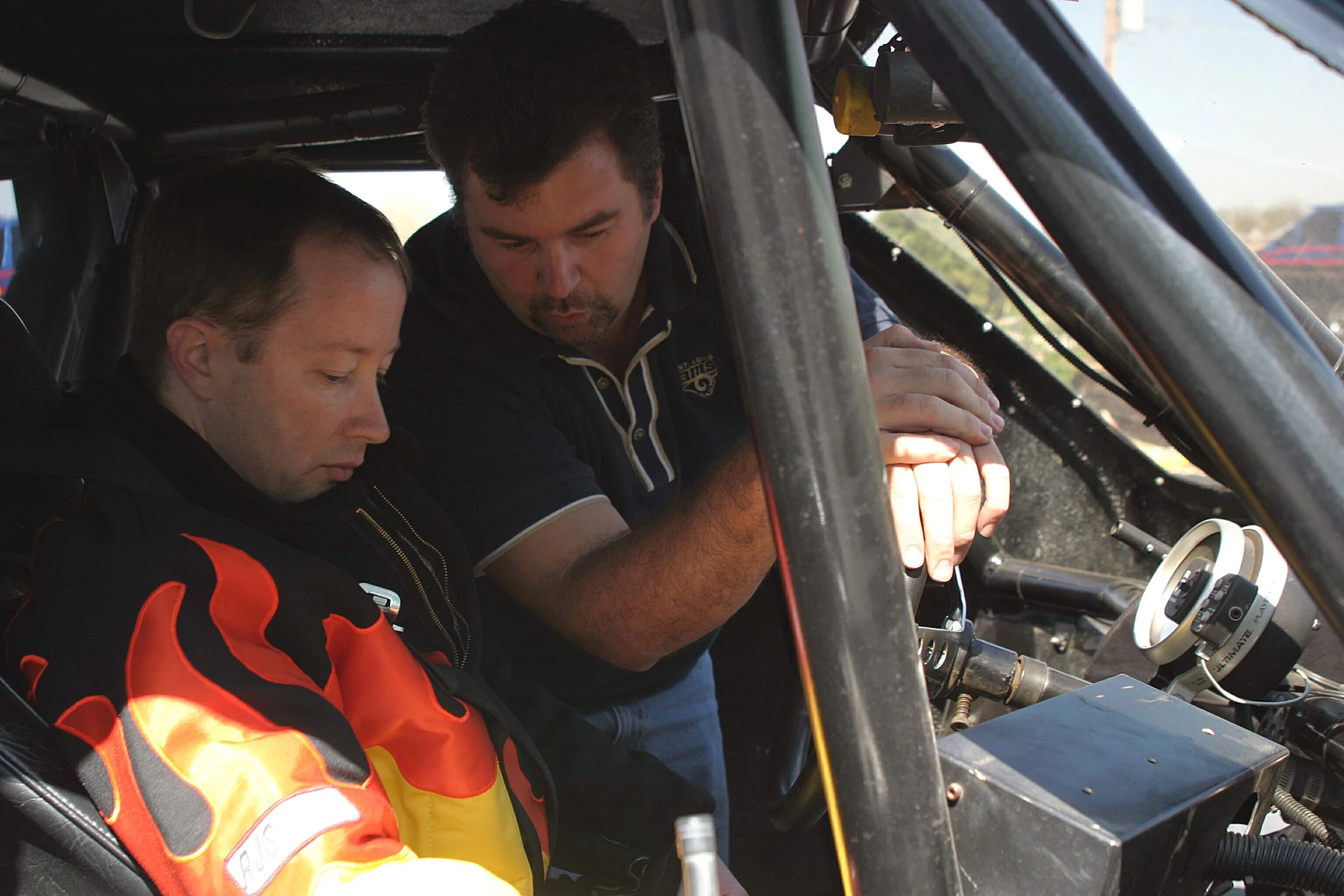  Meagher talks the rookie through the truck’s basic controls and oversees application of the five-point racing harness. 